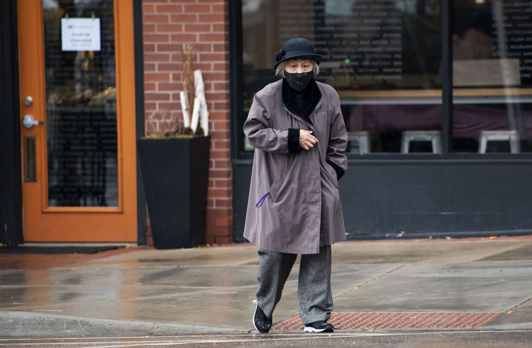 Anna Zoe, who is known as Ma Ma, 78, walks across Peal Street after dropping off food to the business across from her restaurant Zoe Ma Ma in Boulder in October. (Chancey Bush / The Gazette) (Chancey Bush/ The Gazette)