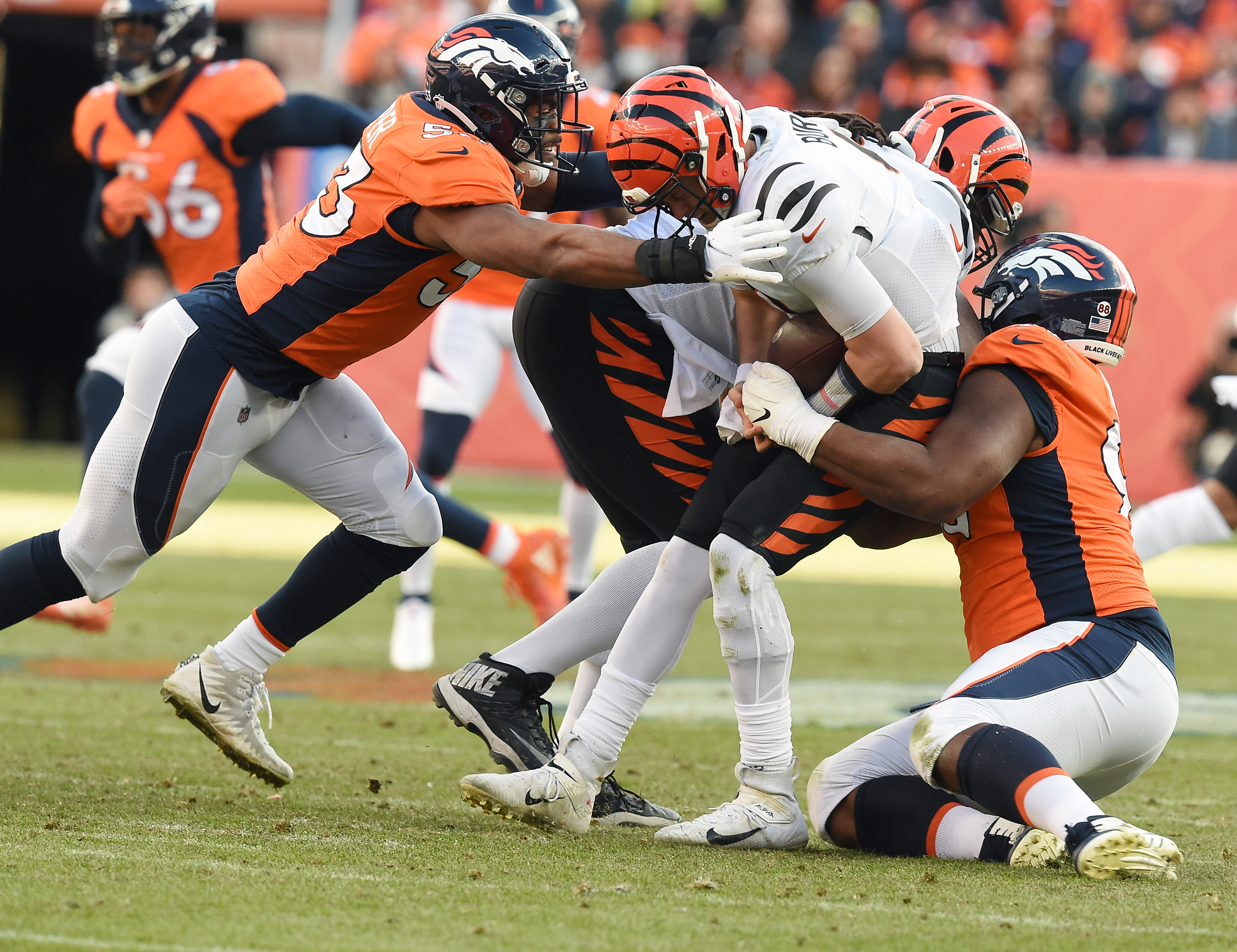 Broncos linebacker Jonathan Cooper and defensive end Shelby Harris sack Bengals quarterback Joe Burrow in the second quarter. The Broncos played the Bengals at Mile High Stadium on Sunday, Dec. 19, 2021. The Broncos lost the game 15-10.(Photo by Jerilee Bennett, The Gazette) (Jerilee Bennett)