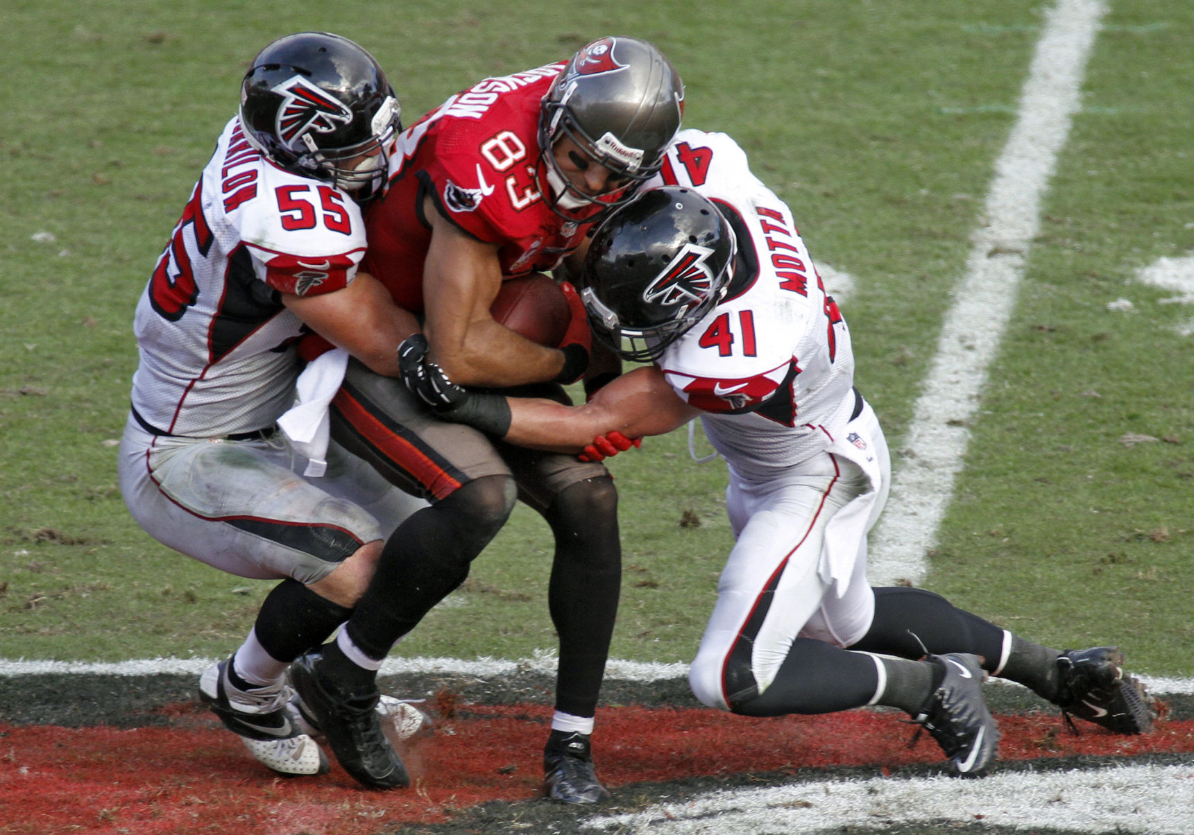 Tampa Bay Buccaneers wide receiver Vincent Jackson (83) is sandwiched by Atlanta Falcons outside linebacker Paul Worrilow (55) and strong safety Zeke Motta (41) after a reception during the fourth quarter of an NFL football game on Sunday, Nov. 17, 2013, in Tampa, Fla. (AP Photo/Reinhold Matay) (Reinhold Matay)