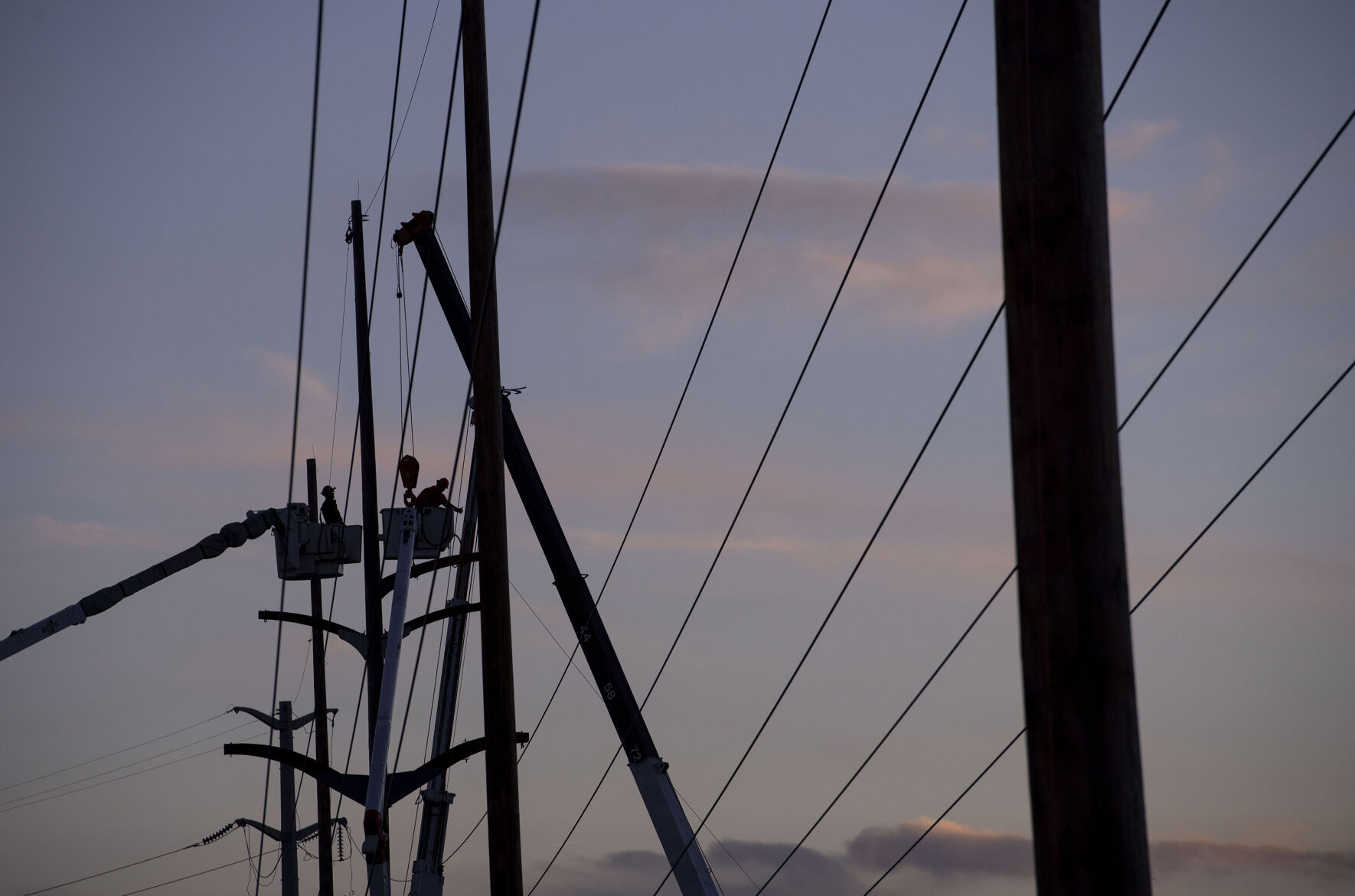 Crews work to fix Colorado Springs Utilities’ poles along Nevada Avenue to restore power to residents without electricity in Colorado Springs on Thursday, Dec. 16, 2021. A wind storm ripped through El Paso County causing major damages to trees, homes, sidewalks and power lines. City crews and tree companies are working to clean up the aftermath of Wednesday’s hurricane-force winds that topped 100 mph in some areas of El Paso County. Colorado Springs Utilities’ crews are working around the clock to fix utility lines and restore power to residents still facing outages in areas. (Chancey Bush/ The Gazette) (Chancey Bush/ The Gazette)