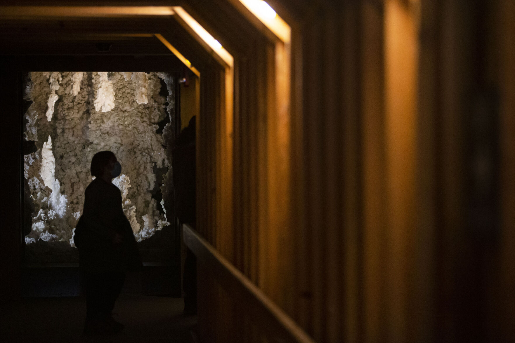 A visitor looks at the Crystal Treasure from Mexico crystal deposit exhibit at the entrance of the Gems and Minerals hall on Monday, Dec. 13, 2021, at the Denver Museum of Nature and Science in Denver, Colo. (Timothy Hurst/The Gazette) (Timothy Hurst)