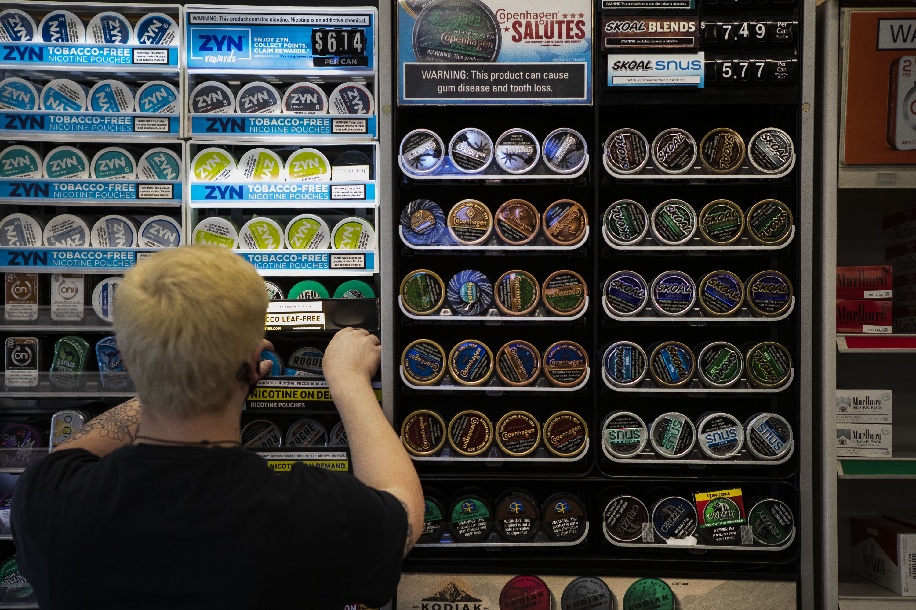 Store manager Taylor Schreiner nicotine pouch canisters at Smoker Friendly on South Broadway on Tuesday, Dec. 7, 2021, in Denver, Colo. (Timothy Hurst/The Gazette) (Timothy Hurst)