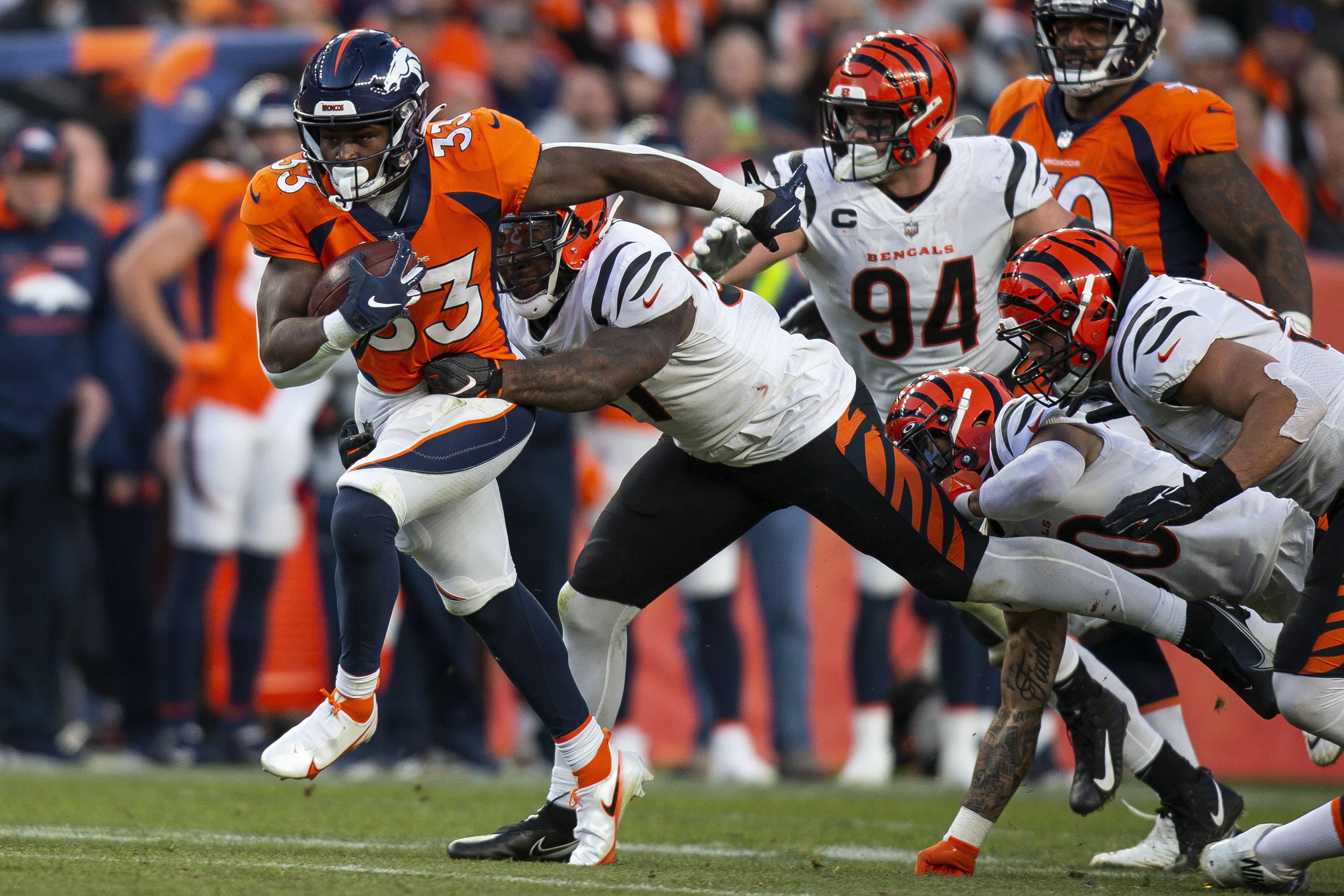 Denver Broncos running back Javonte Williams (33) drags Cincinnati Bengals linebacker Germaine Pratt (57) on a run up the gut on Sunday, Dec. 19, 2021, at Empower Field at Mile High in Denver, Colo. (Timothy Hurst/The Gazette) (TimHursttim.hurst@gazette.comhttps://secure.gravatar.com/avatar/aca82bd62b4ee425c598527cd6faa1b1?d=mm&r=g)