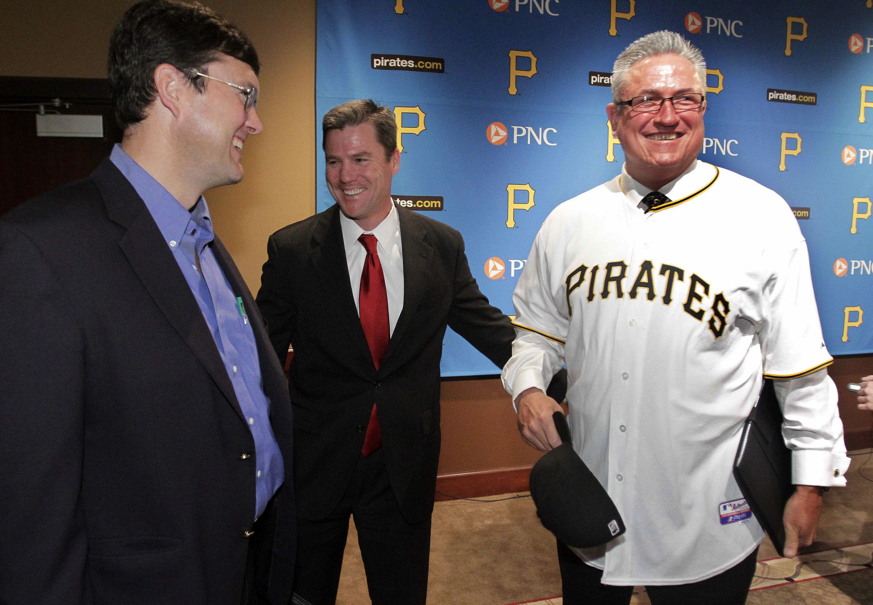 FILE - In this Nov. 15, 2010, file photo, Pittsburgh Pirates new manager Clint Hurdle, right, shares a moment with team chairman of the board Bob Nutting, left, and president Frank Coonelly after being introduced as the 39th manager in the history of the Pirates. A packed stadium, a roster filled with homegrown talent and a team streaking to the postseason has become something of a September tradition in Pittsburgh. (AP Photo/Gene J. Puskar, FILE) (Gene J. Puskar)