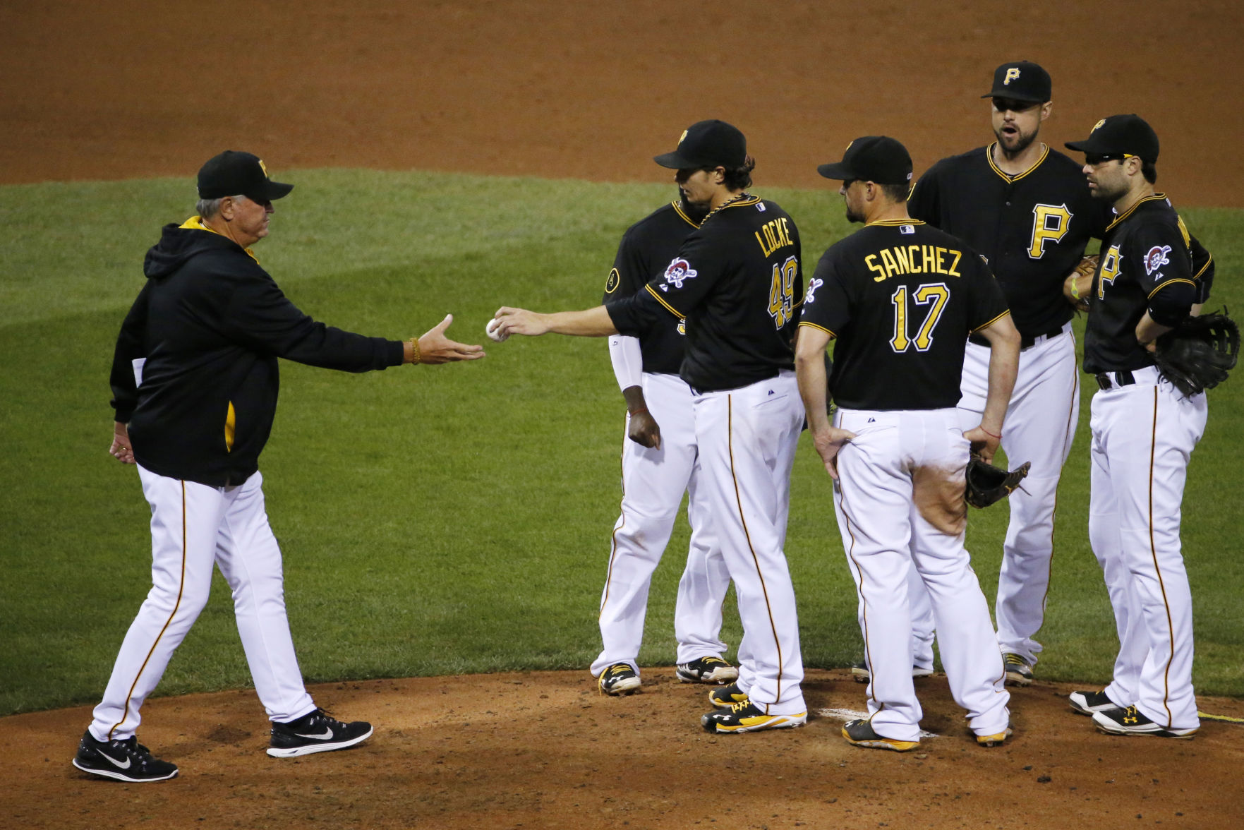 Pittsburgh Pirates starting pitcher Jeff Locke, center, hands the ball to manager Clint Hurdle, left, as he is removed in the the sixth inning of a baseball game againast the Chicago Cubs in Pittsburgh Saturday, Sept. 13, 2014. The Cubs won 6-4. (AP Photo/Gene J. Puskar) (Gene J. Puskar)