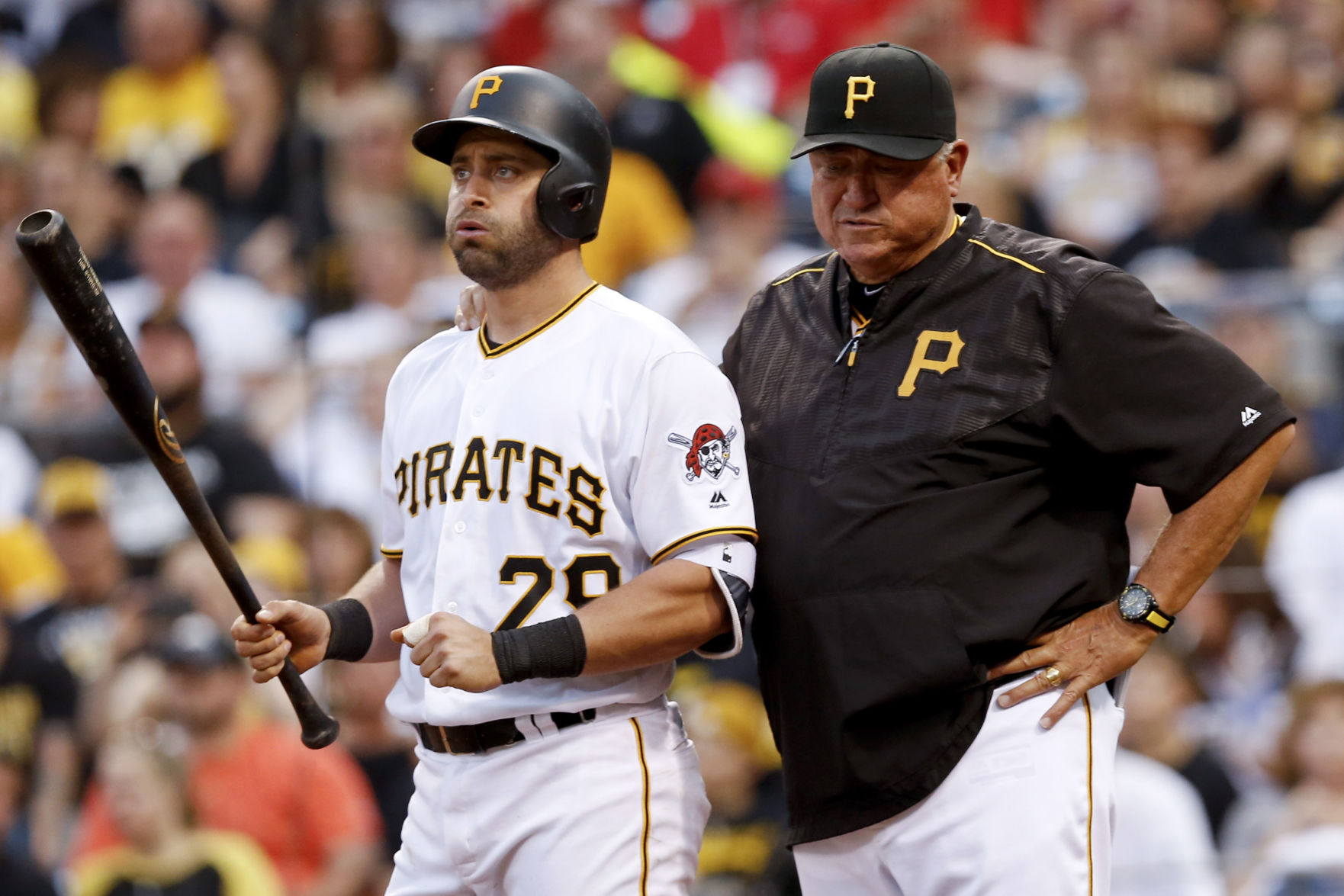 Pittsburgh Pirates' Francisco Cervelli stands with manager Clint Hurdle after suffering an injury while batting against the St. Louis Cardinals during the fourth inning of a baseball game, Friday, June 10, 2016, in Pittsburgh. Cervelli left the game and was replaced by catcher Chris Stewart. (AP Photo/Keith Srakocic) (Keith Srakocic)