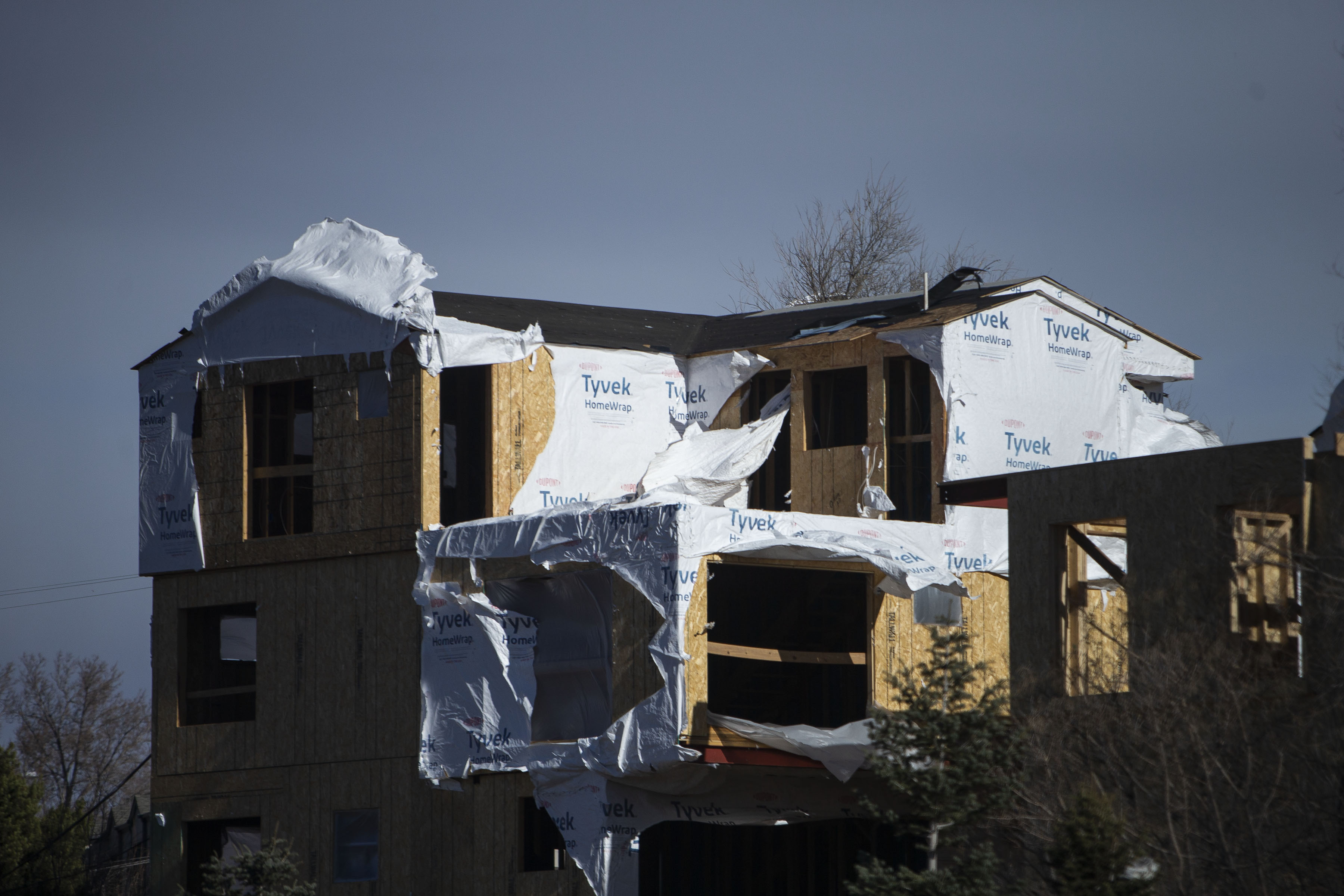 The insulating wrap of a building under construction flaps in the wind on Wednesday, Dec. 15, 2021, in Littleton, Colo. (Timothy Hurst/The Gazette) (Timothy Hurst)