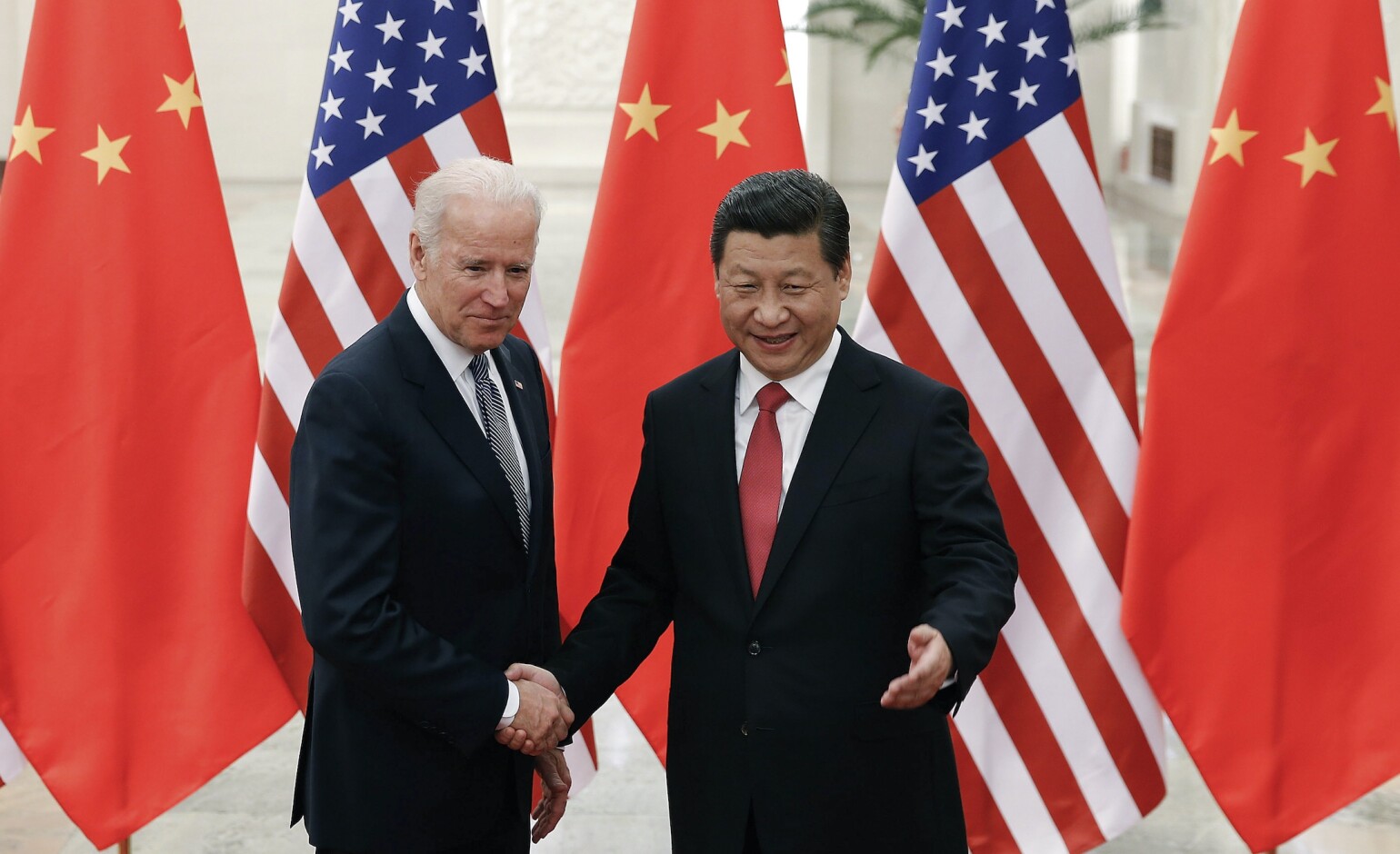 FILE - In this Dec. 4, 2013, file photo, Chinese President Xi Jinping, right, shakes hands with then U.S Vice President Joe Biden as they pose for photos at the Great Hall of the People in Beijing. (AP Photo/Lintao Zhang, Pool) (Lintao Zhang/AP)