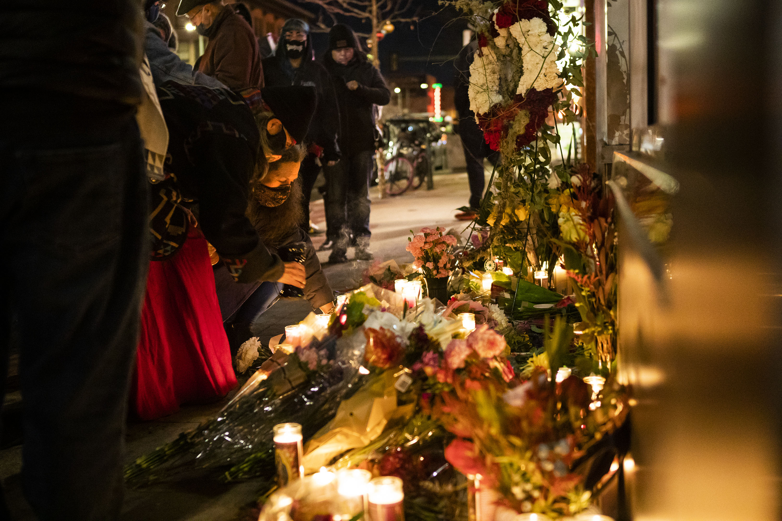 Mourners gather at a candle-filled memorial for slain artist and activist Alicia Cardenas, the owner of Sol Tribe Custom Tattoo and Body Piercing, who was killed in a shooting spree that left five victims dead the previous night, as on Tuesday, Dec. 28, 2021, at Sol Tribe Custom Tattoo in Denver, Colo. (Timothy Hurst/The Gazette) (Timothy Hurst)