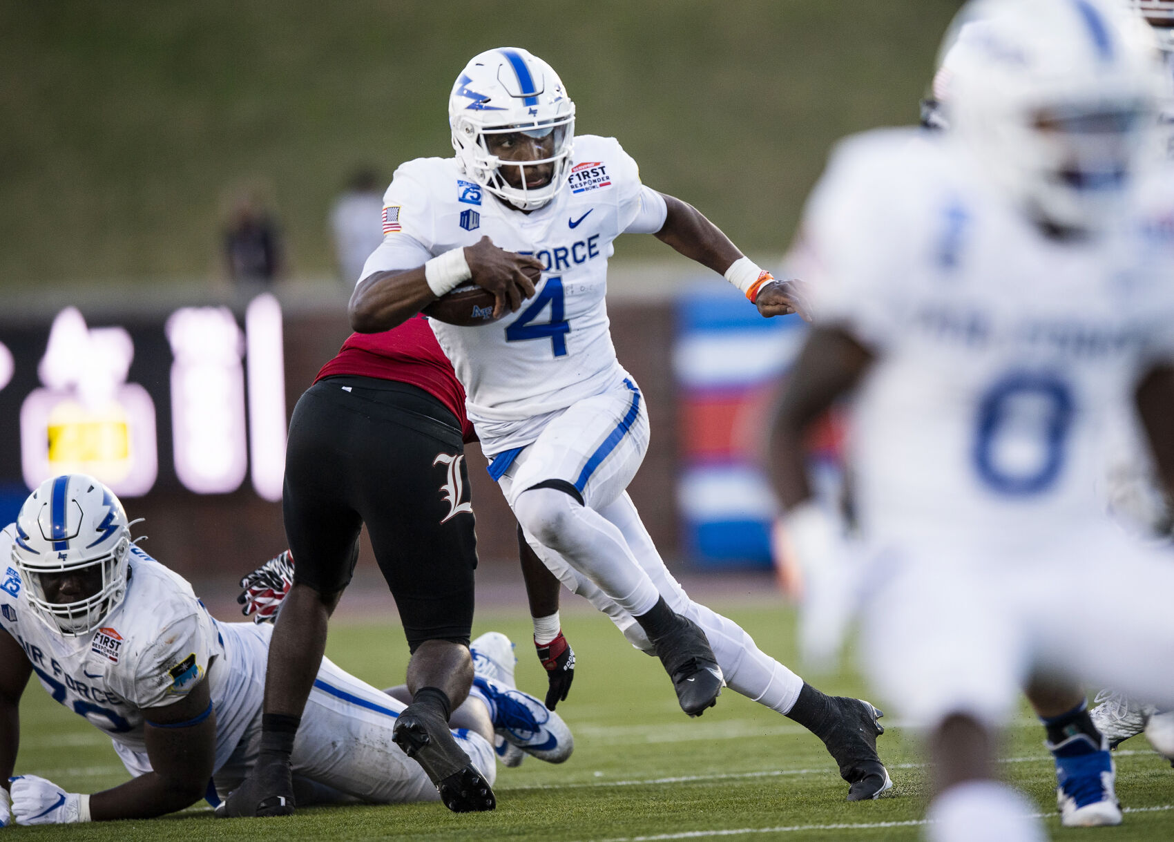 Air Force junior quarterback Haaziq Daniels (4) carries the ball as the Air Force Falcons take on the Louisville Cardinals during the 2021 First Responder Bowl at Gerald J. Ford Stadium on the campus of Southern Methodist University in Dallas, Texas on Tuesday, Dec. 28, 2021. The Falcons defeated the Cardinals and won the bowl game by a score of 31-28. (Chancey Bush/ The Gazette) (Chancey Bush/ The Gazette)