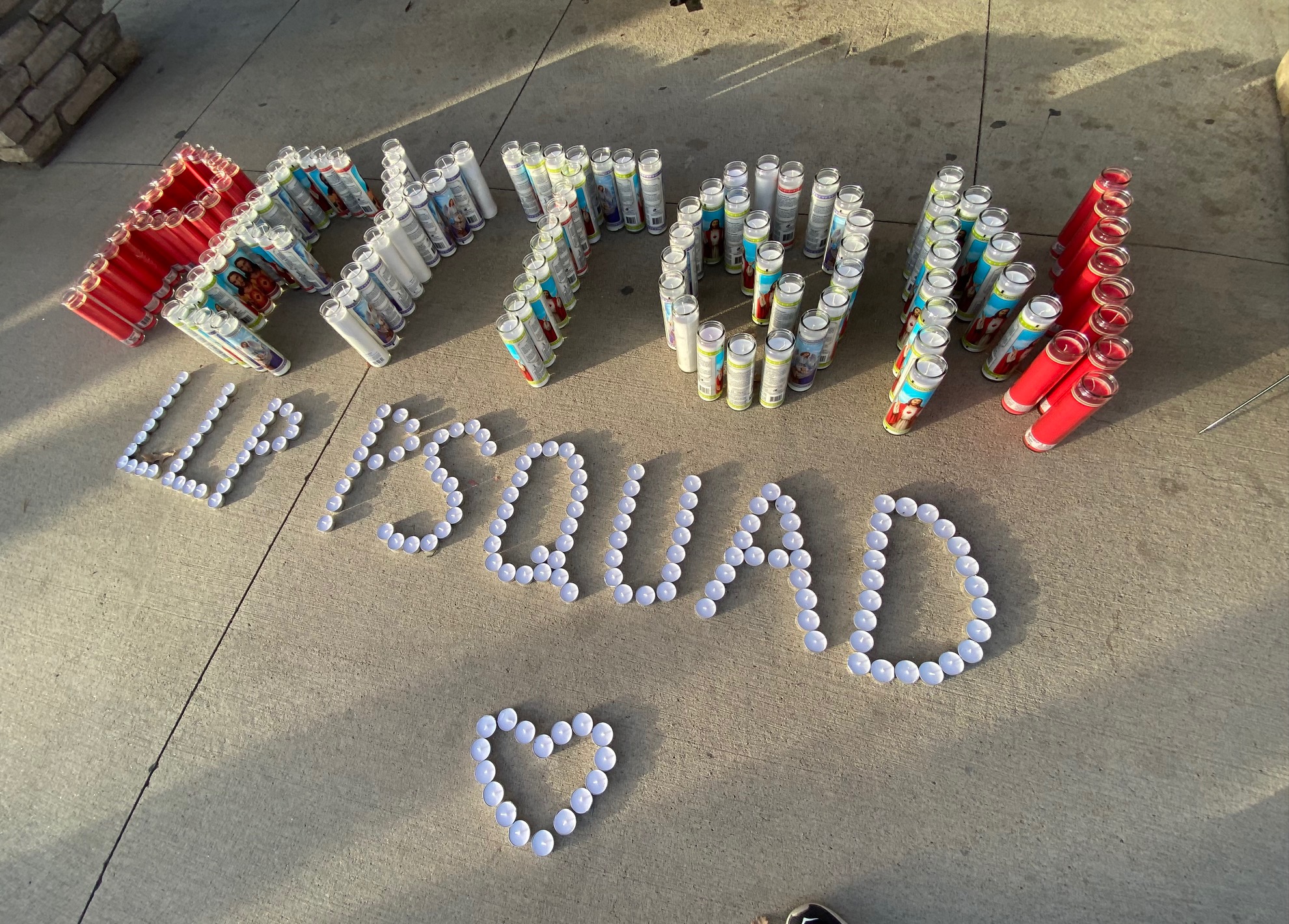 Red and white candles spell Peyton and LLP, (Long Live Peyton) which was a common message during Peyton Blitstein's vigil at Aurora's Triangle Park, at 1600 Espana Street Sunday. (Carol McKinley)