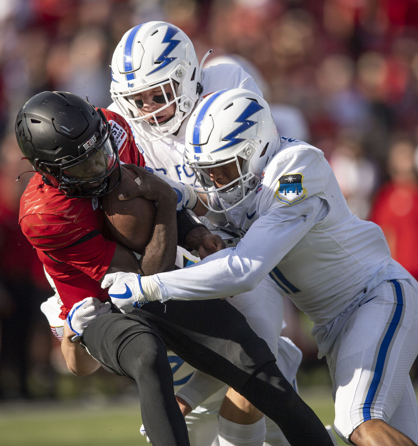 Air Force sophomores Bo Richter (31) and Camby Goff (11) take down Louisville junior quarterback Malik Cunningham (3) as the Air Force Falcons take on the Louisville Cardinals during the 2021 First Responder Bowl at Gerald J. Ford Stadium on the campus of Southern Methodist University in Dallas, Texas on Tuesday, Dec. 28, 2021. The Falcons defeated the Cardinals and won the bowl game by a score of 31-28. (Chancey Bush/ The Gazette) (Chancey Bush/ The Gazette)