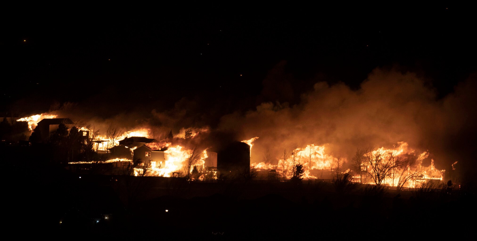 Fire moves through a suburban neighborhood on Thursday, Dec. 30, 2021, in Superior, Colo. (Timothy Hurst/The Gazette) (Timothy Hurst)