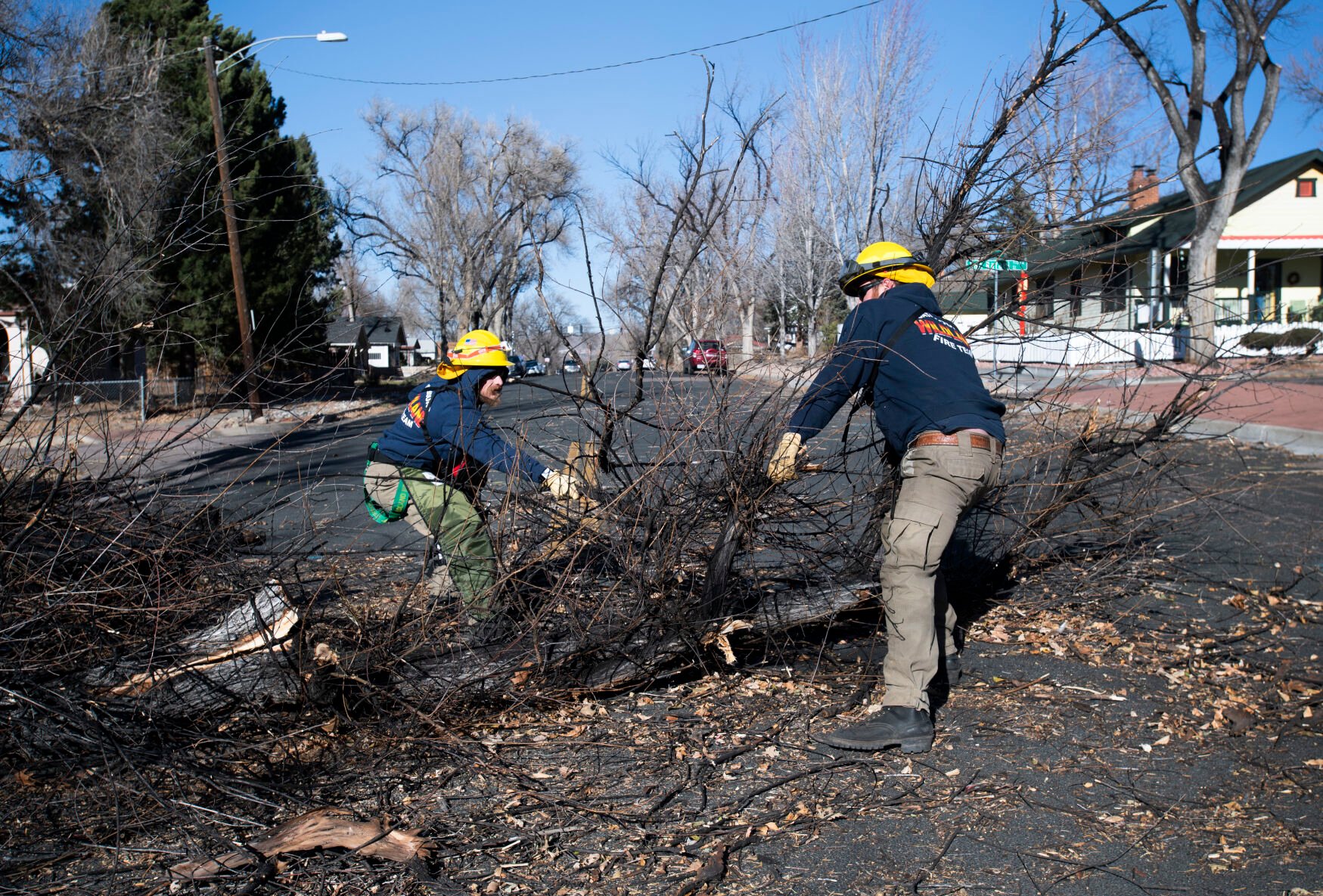 A crew from Colorado Springs Utilities clear Hancock Avenue near Unitah Street in Colorado Springs after a wind storm with gusts more than 100 mph hit the Pikes Peak Region Wednesday, Dec. 15, 2021. (The Gazette, Christian Murdock) (Christian Murdock/The Gazette)