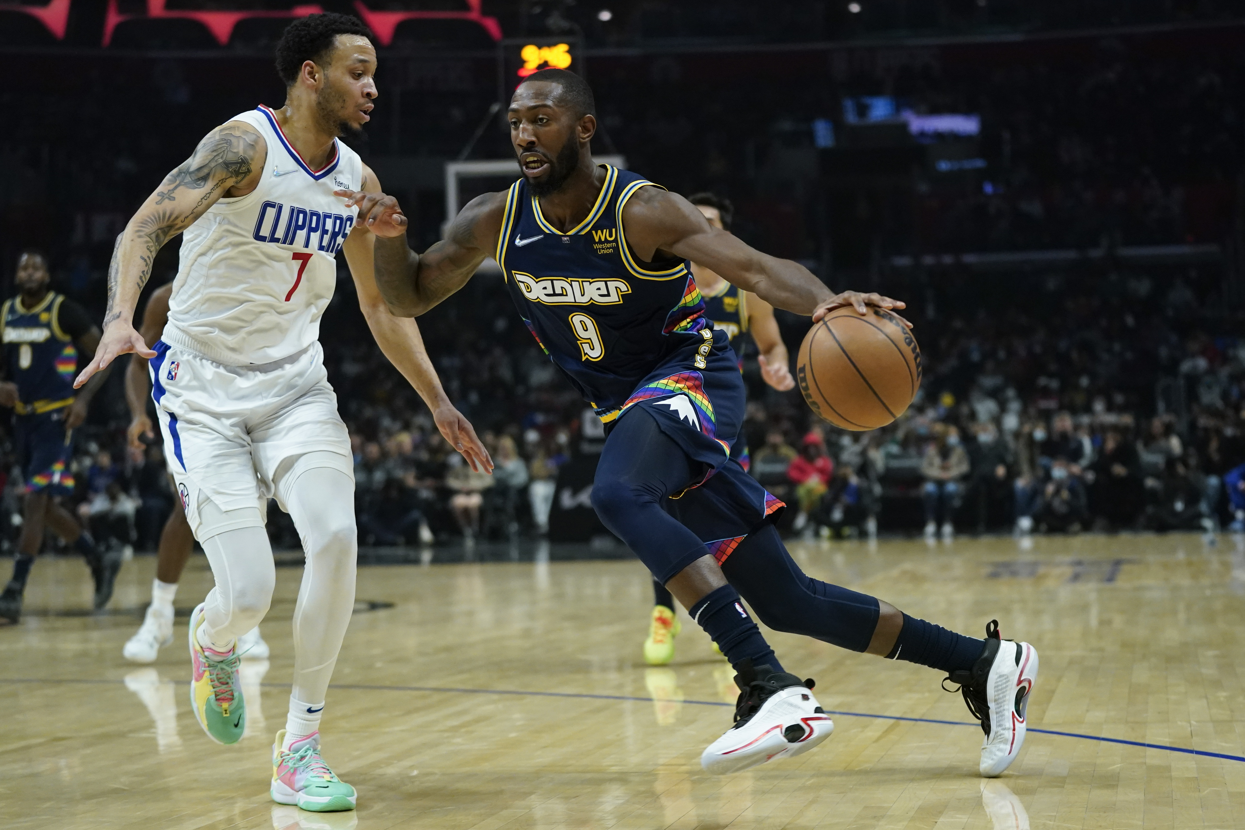 Los Angeles Clippers guard Amir Coffey (7) defends against Denver Nuggets guard Davon Reed (9) during the first half of an NBA basketball game in Los Angeles, Sunday, Dec. 26, 2021. (AP Photo/Ashley Landis) (Ashley Landis)