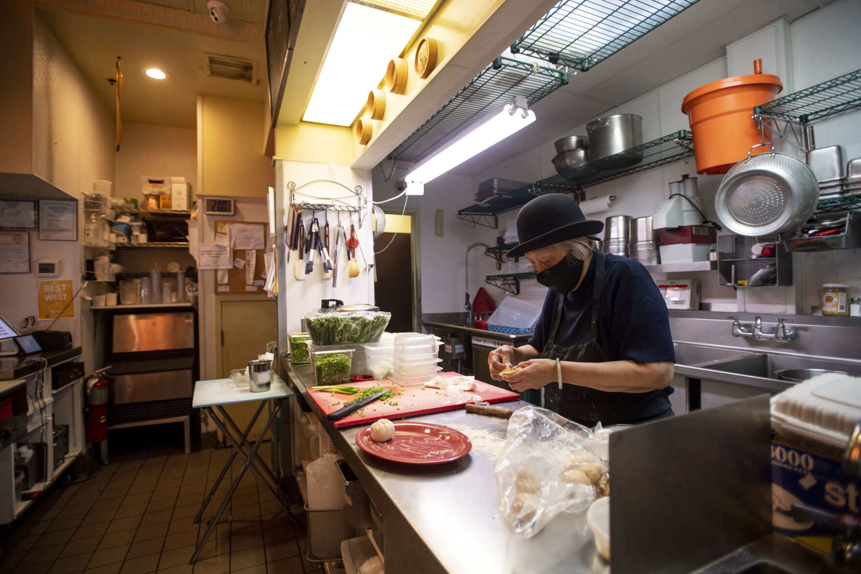 Anna Zoe, known as Ma Ma, 78, makes her special cuisine street food at her restaurant Zoe Ma Ma located on Pearl Street in Boulder in October. (Chancey Bush / The Gazette) (Chancey Bush/ The Gazette)