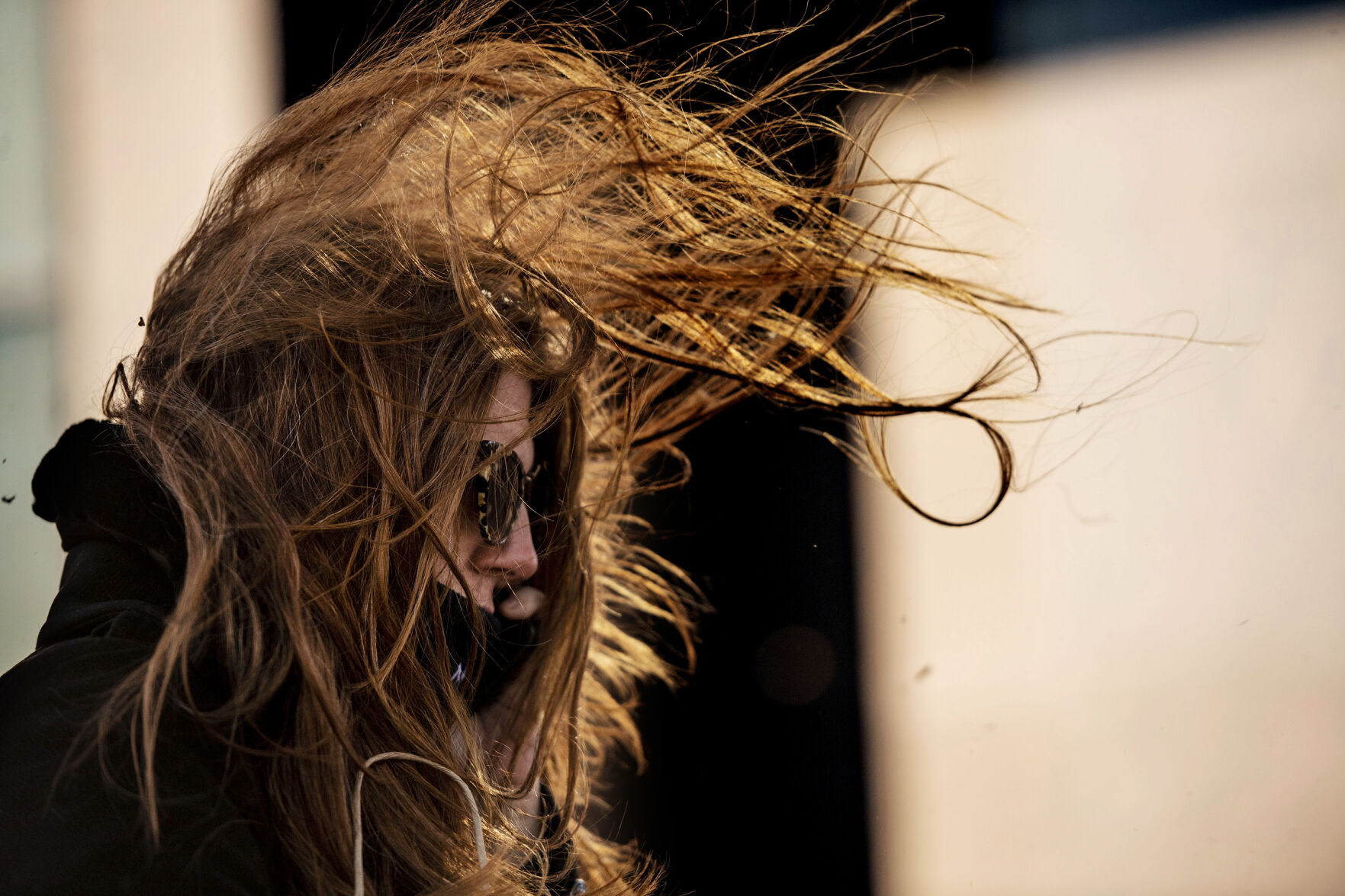Shannon Howell braves the strong winds in downtown Colorado Springs during a wind storm that swept through El Paso County on Wednesday, Dec. 15, 2021. (Chancey Bush/ The Gazette) (Chancey Bush/ The Gazette)
