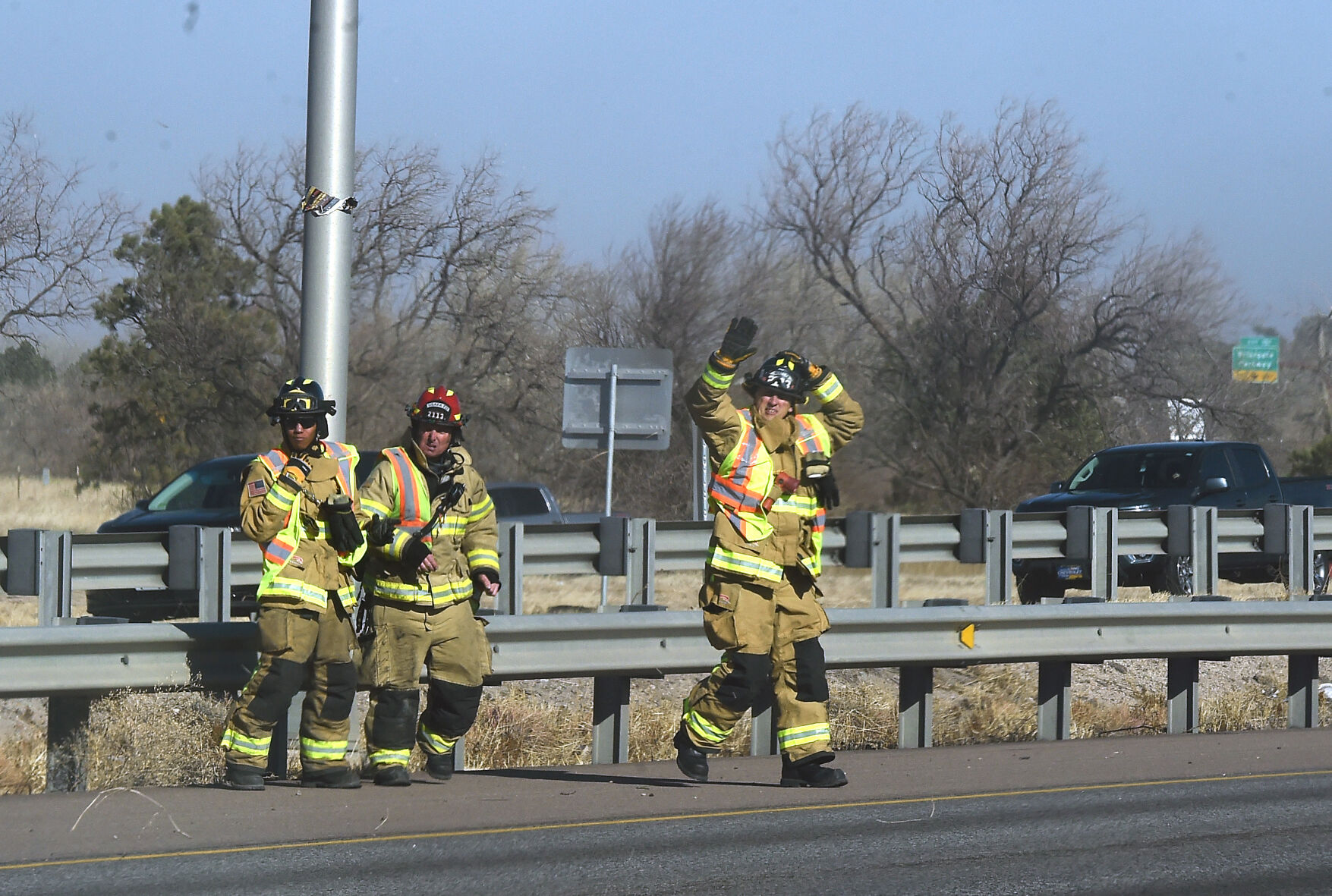 After checkin on a wrecked A semi-truck just north of N. Academy Blvd. in the southbound lanes, firefighters cross the highway to check on an overturned semi on the onramp of I-25. Over a dozen semi trucks were blown over by high winds in the Pikes Peak region on I-25. (Photo by Jerilee Bennett, The Gazette) (Jerilee Bennett)