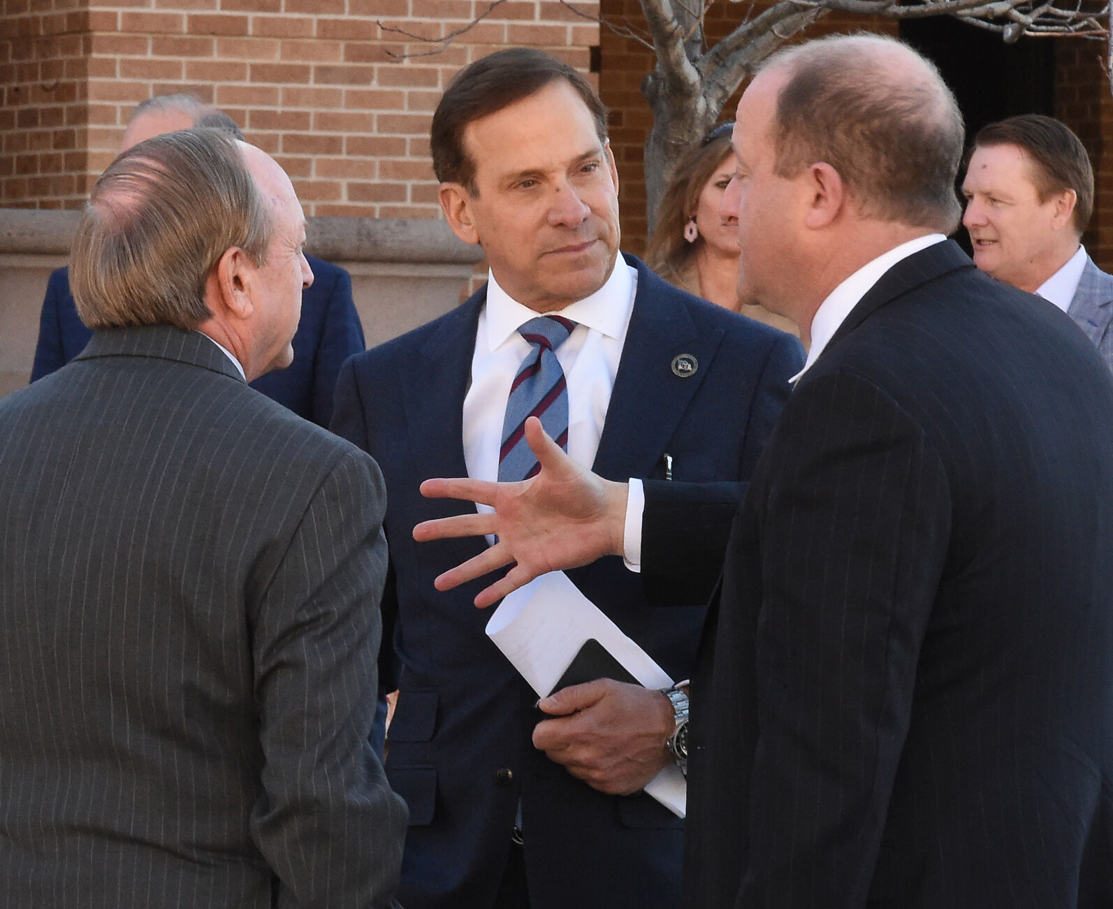 Governor Jared Polis (center) traveled to the UCCS campus to announce the appointment of Republican Ken Montera to the vacant seat on the University of Colorado Board of Regents that represents Colorado’s 5th Congressional District. Montera (center) speaks with Mayor John Suthers and Gov. Jared Polis before the announcement of the governor on Monday, Dec. 20, 2021. (Photo by Jerilee Bennett, The Gazette) (Jerilee Bennett/The Gazette)