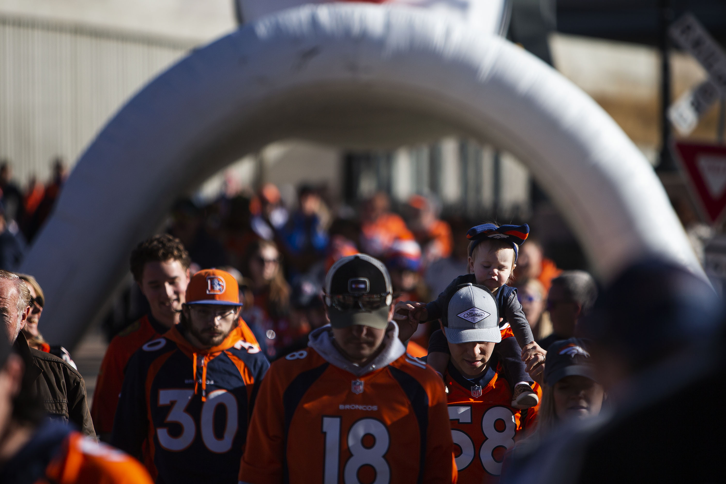 Collins Haight, 1, is carried toward the stadium by Ryan Haight before the Denver Broncos take on the Cincinnati Bengals on Sunday, Dec. 19, 2021, at Empower Field at Mile High in Denver, Colo. (Timothy Hurst/The Gazette) (Timothy Hurst)