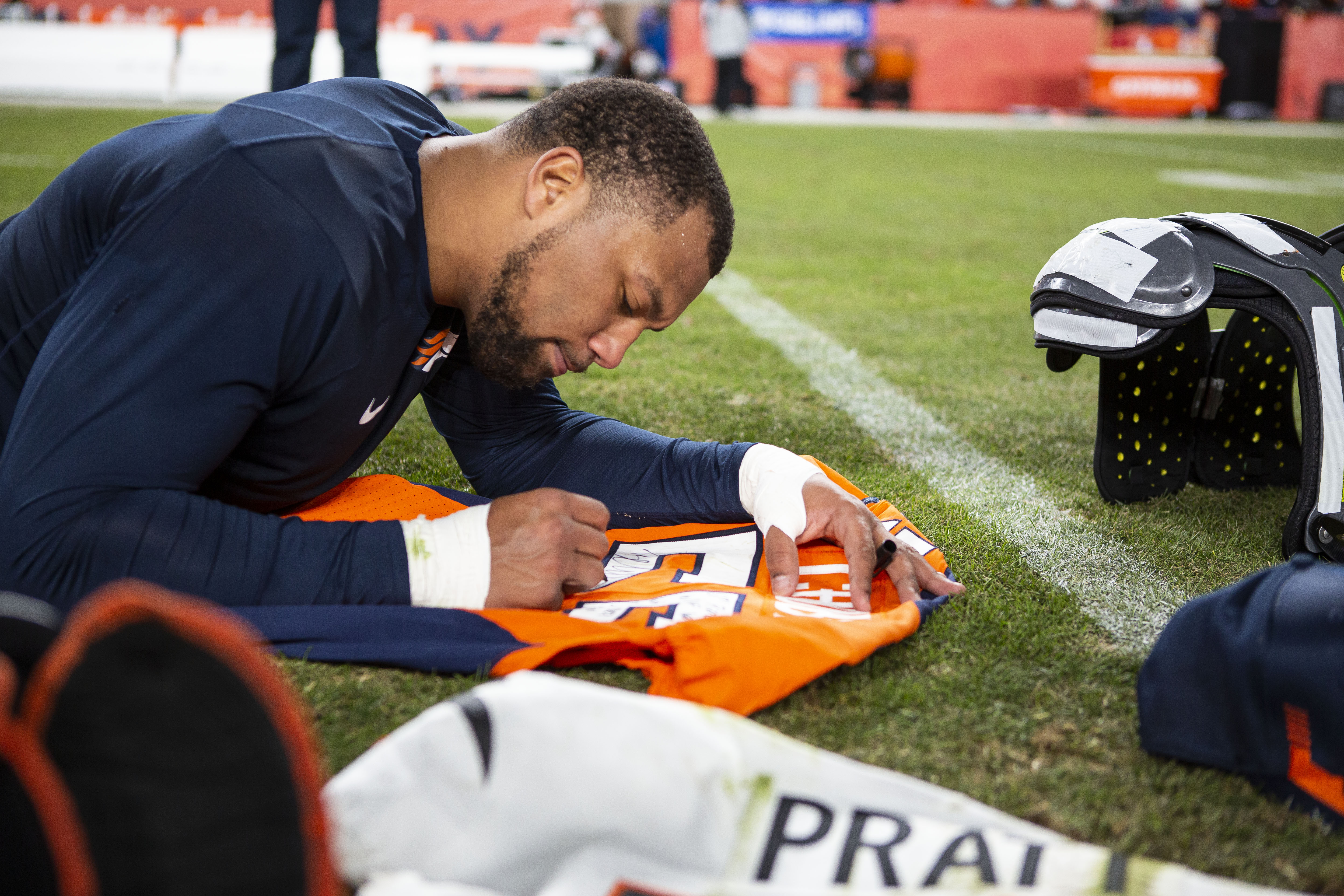 Denver Broncos outside linebacker Bradley Chubb (55) signs his jersey for a Cincinnati Bengals players after a game on Sunday, Dec. 19, 2021, at Empower Field at Mile High in Denver, Colo. (Timothy Hurst/The Gazette) (TimHursttim.hurst@gazette.comhttps://secure.gravatar.com/avatar/aca82bd62b4ee425c598527cd6faa1b1?d=mm&r=g)