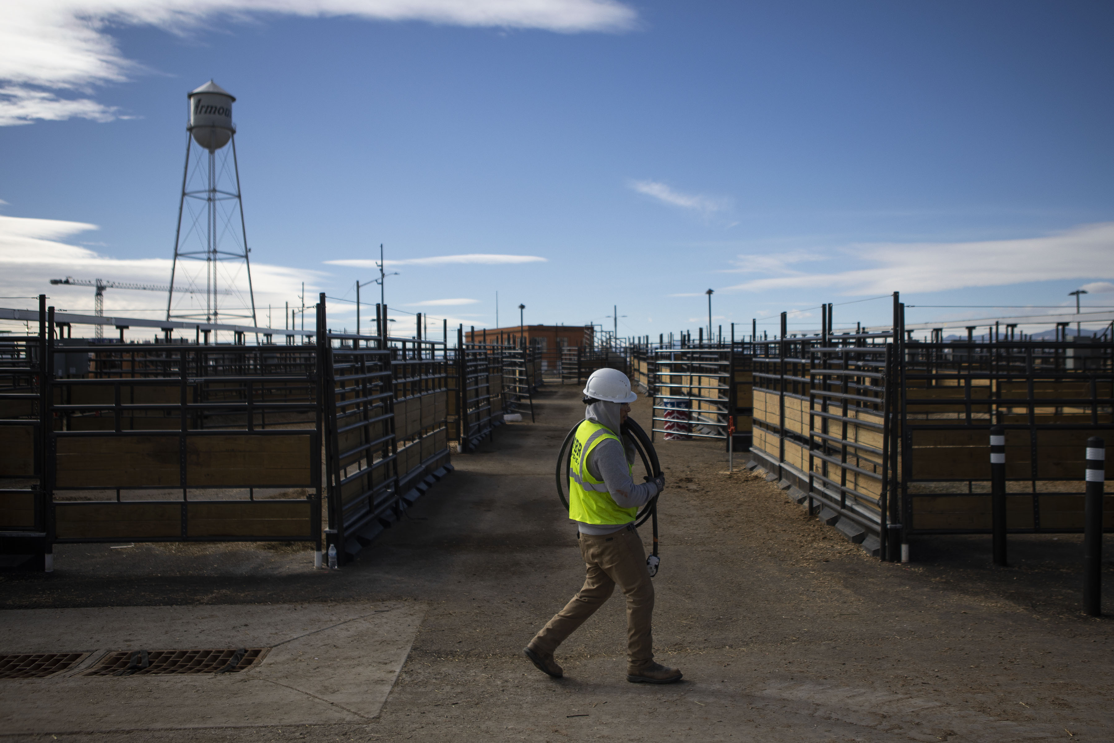 MBP electrician Eric Perez carries a coil of wire away as he and other electricians work to remove all the electrical connections from the now-empty Cille and Ron Williams stockyards the day after the end of the National Western Stock Show on Monday, Jan. 24, 2022, in Denver, Colo. (Timothy Hurst/The Gazette) (Timothy Hurst)