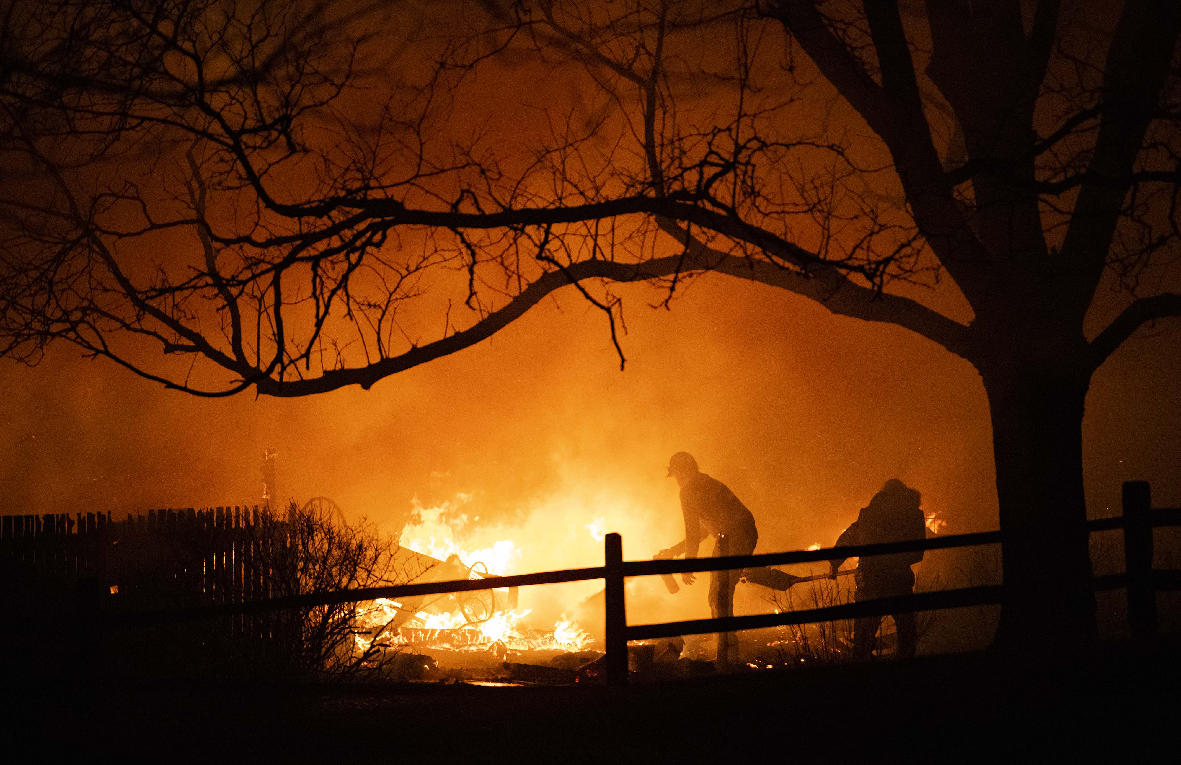 Residents fight a fire Thursday, Dec. 30, 2021, as it burns through a neighborhood in Louisville, Colo. The fire, fueled by high winds, burned through Boulder County destroying hundreds on homes and businesses. (The Gazette, Christian Murdock (Christian Murdock/The Gazette)