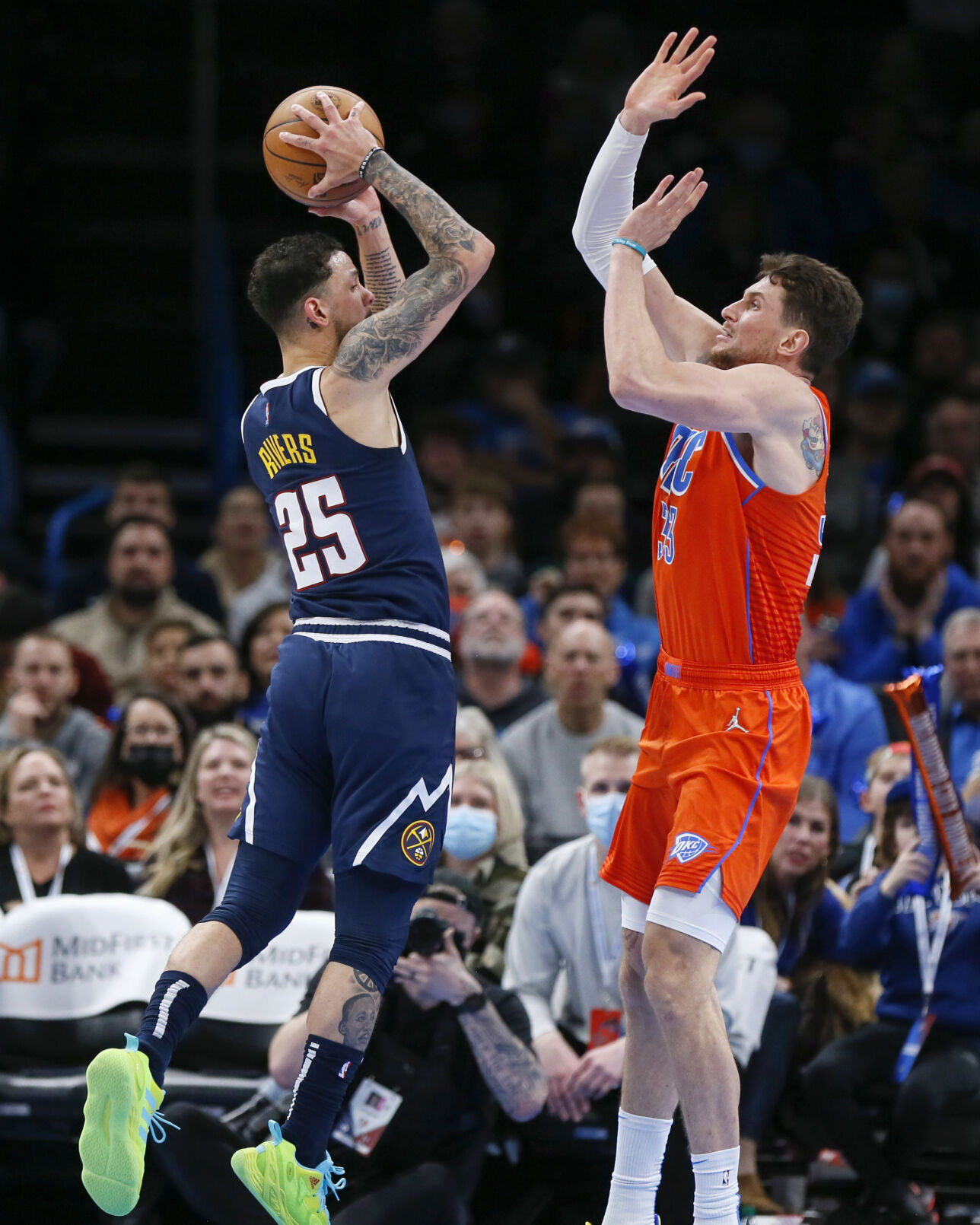 Denver Nuggets guard Austin Rivers (25) tries to score against Oklahoma City Thunder center Mike Muscala (33) in the second half of an NBA basketball game, Sunday, Jan. 9, 2022, in Oklahoma City. (AP Photo/Nate Billings) (Nate Billings)