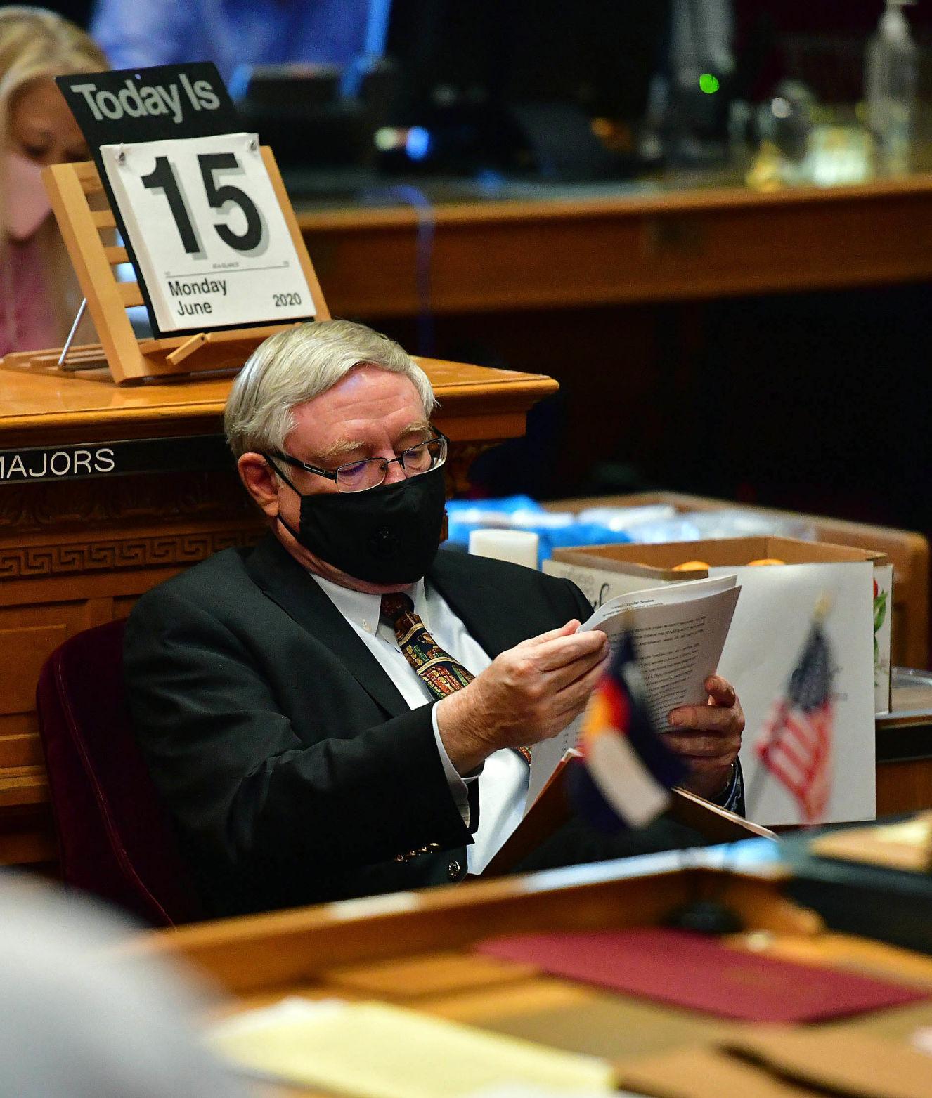 On the last day of legislation, a mask clad Sen. Bob Gardner, R-Colorado Springs, looks over some paperwork while waiting to speak. Because of a long recess attributed to the COVID-19 pandemic, this is the latest day in the year for a regular session. The session was supposed to end on Saturday, but carried over to late in the day on Monday, June 15, 2020. (Photo by Jerilee Bennett, The Gazette) (JERILEE BENNETT THE GAZETTE)