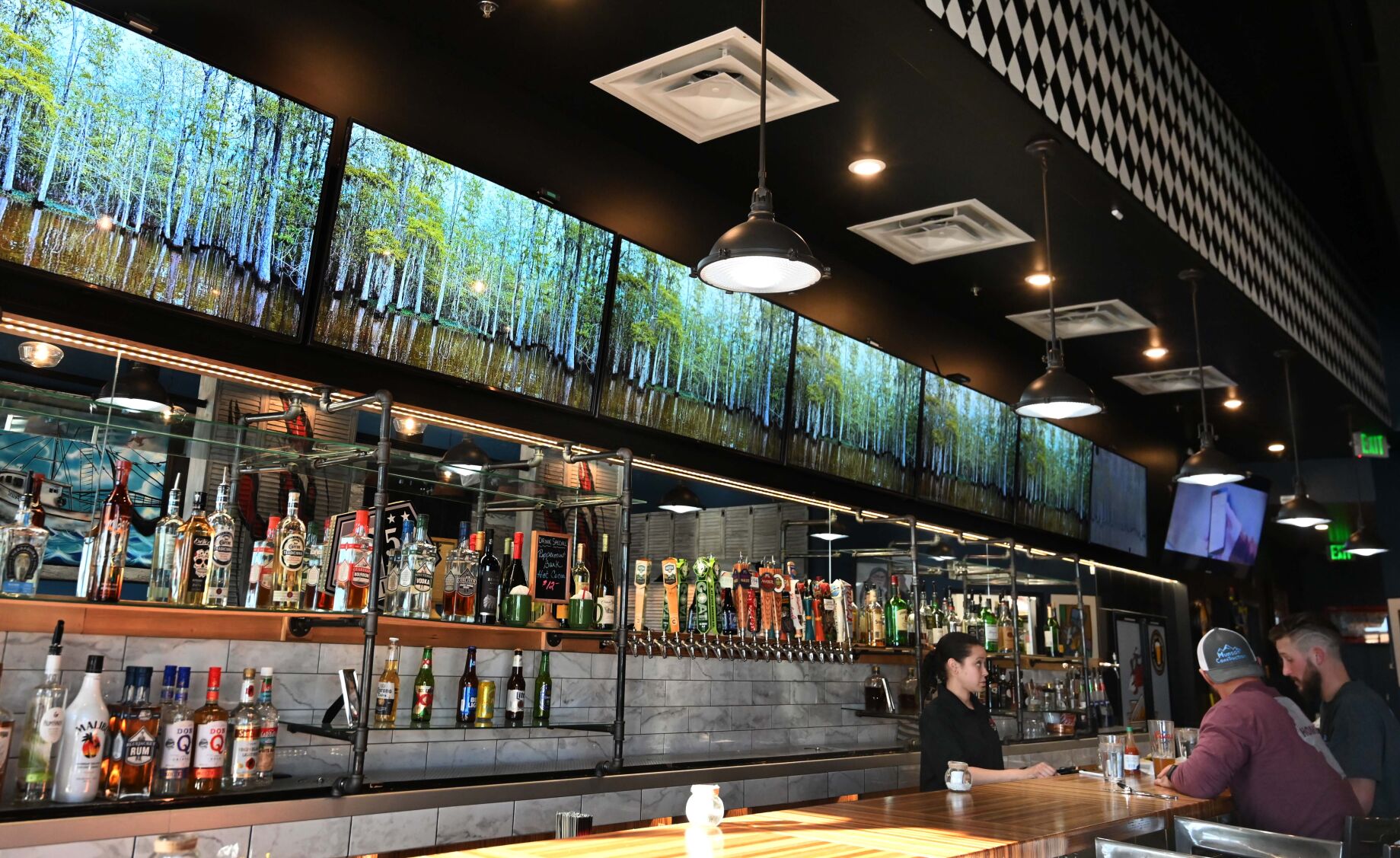 A mural of a swamp is created by using lined- up televisions in Mama Pearl’s Cajun Kitchen. The restaurant got a fresh, upscale look during a visit by Robert Irvine’s “Restaurant Impossible,” but the menu has basically the same Cajun delights that have kept Momma Pearl’s doors open all these years. (Jerilee Bennett, the gazette)
