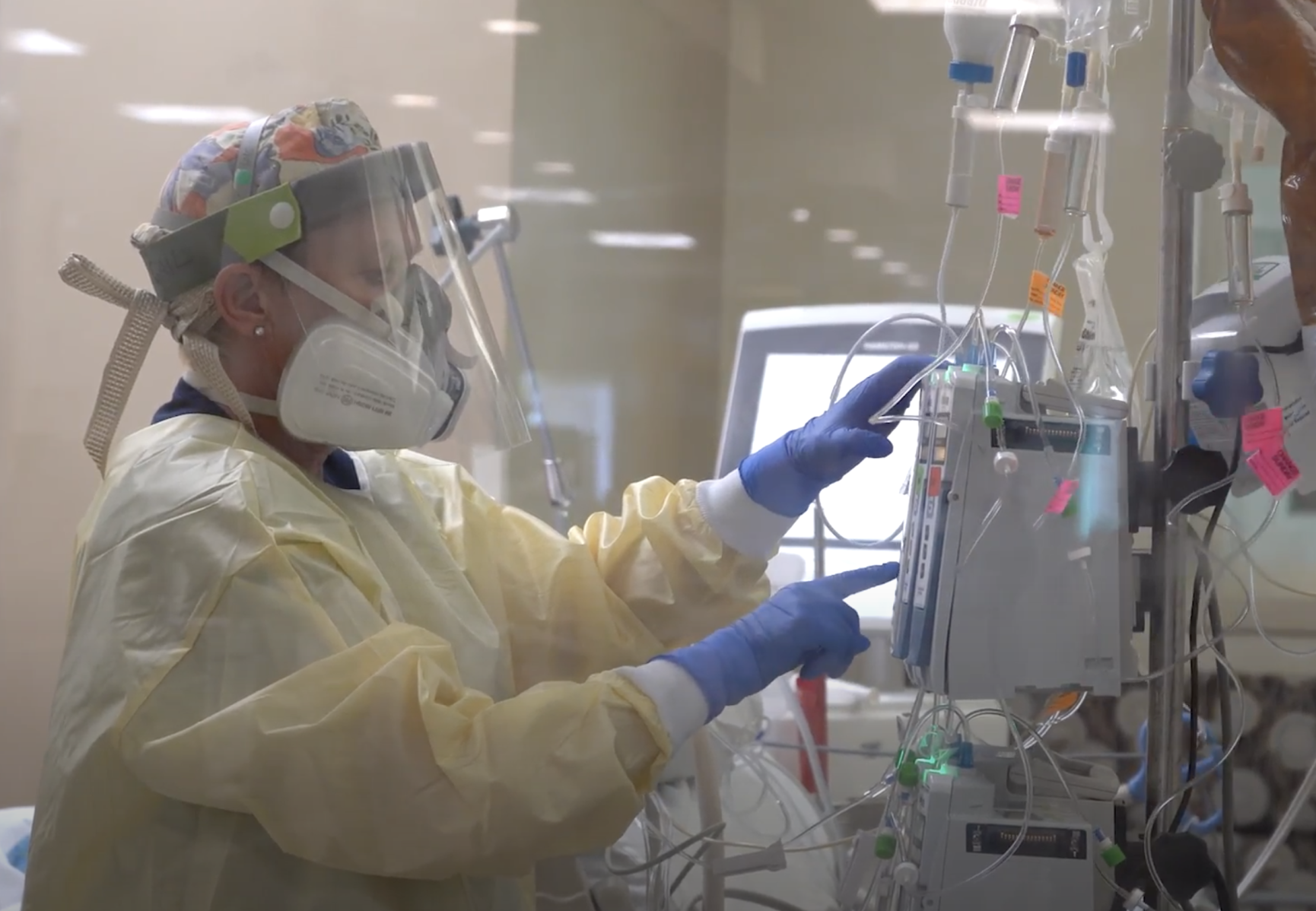 Registered nurse Gail Balbier adjusts a patient’s IV pump inside one of the ICU units at UCHealth University of Colorado Hospital that are dedicated to patients with COVID-19. (Courtesy of UCHealth)