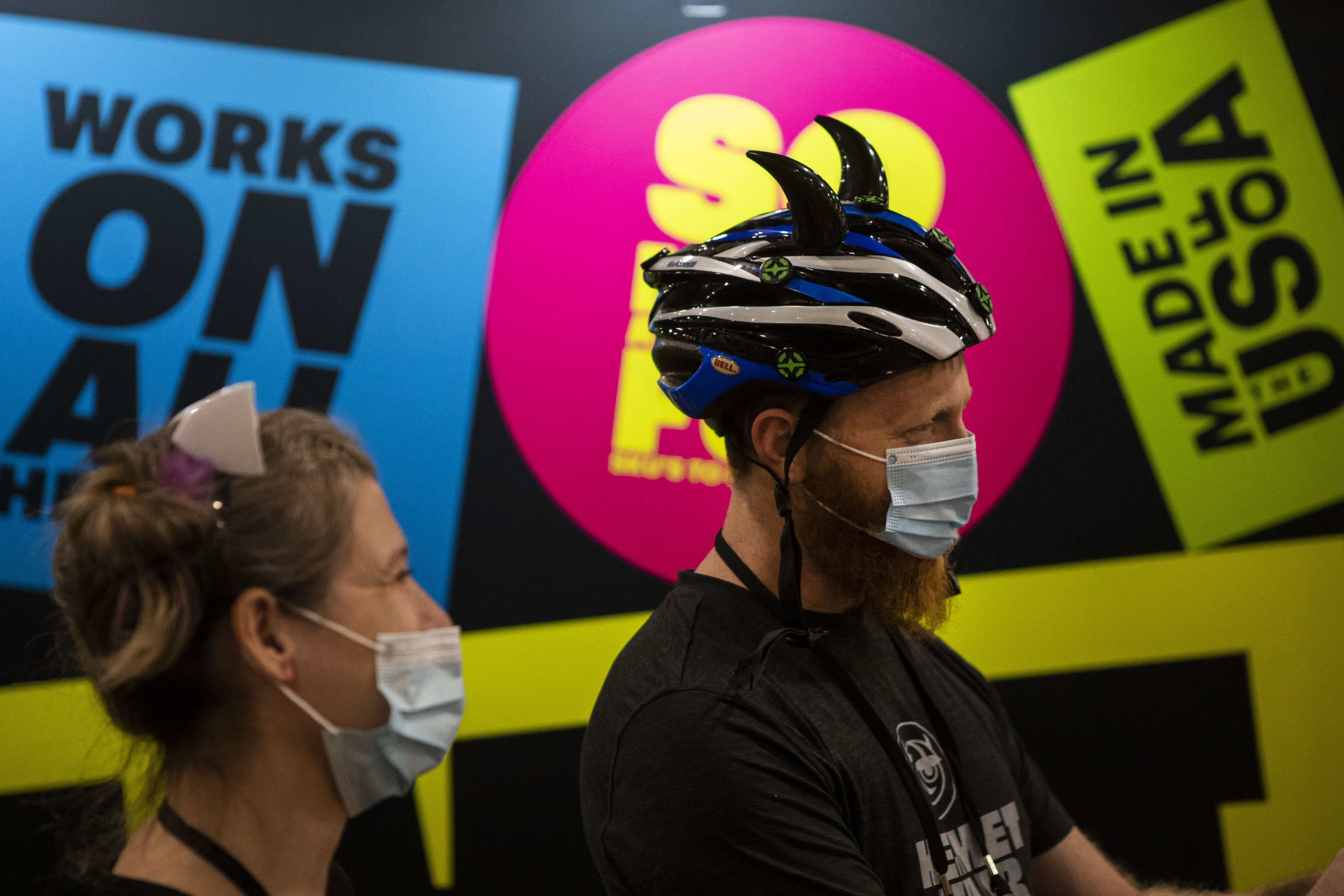 Jess Candelaria and Shaun Oshman with Boulder bases company Helmet Flair sports the magnetizing flair on their heads during the second day of the Outdoor Retailer Snow Show at the Colorado Convention Center on Thursday, Jan. 27, 2022, in Denver, Colo. (Timothy Hurst/The Gazette) (Timothy Hurst/The Denver Gazette)