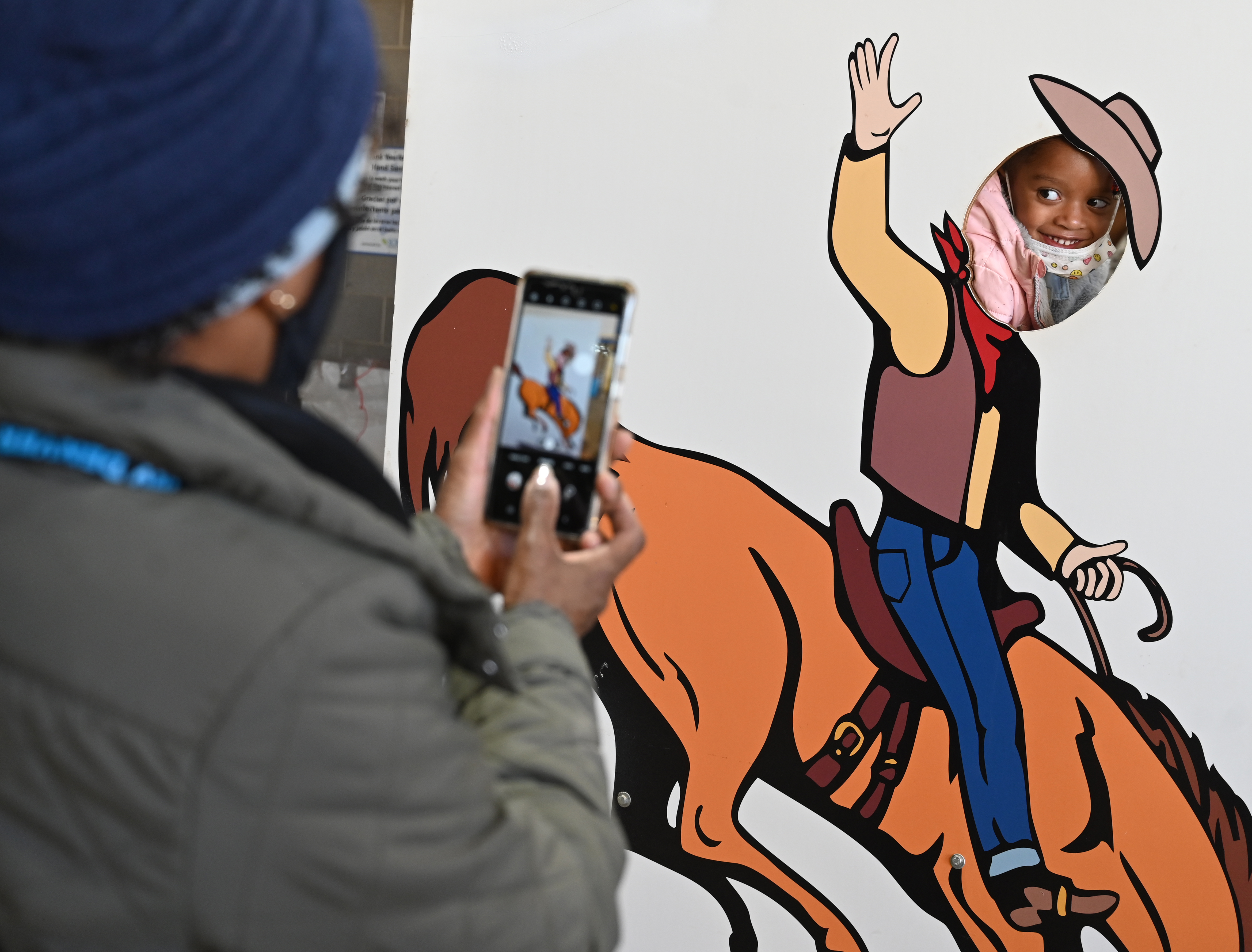 Zola Simpson has her photo taken by her grandmother, Diane Simpson, on the last day of the National Western Stock Show on Sunday, Jan. 23, 2022. (Photo by Jerilee Bennett, The Gazette)