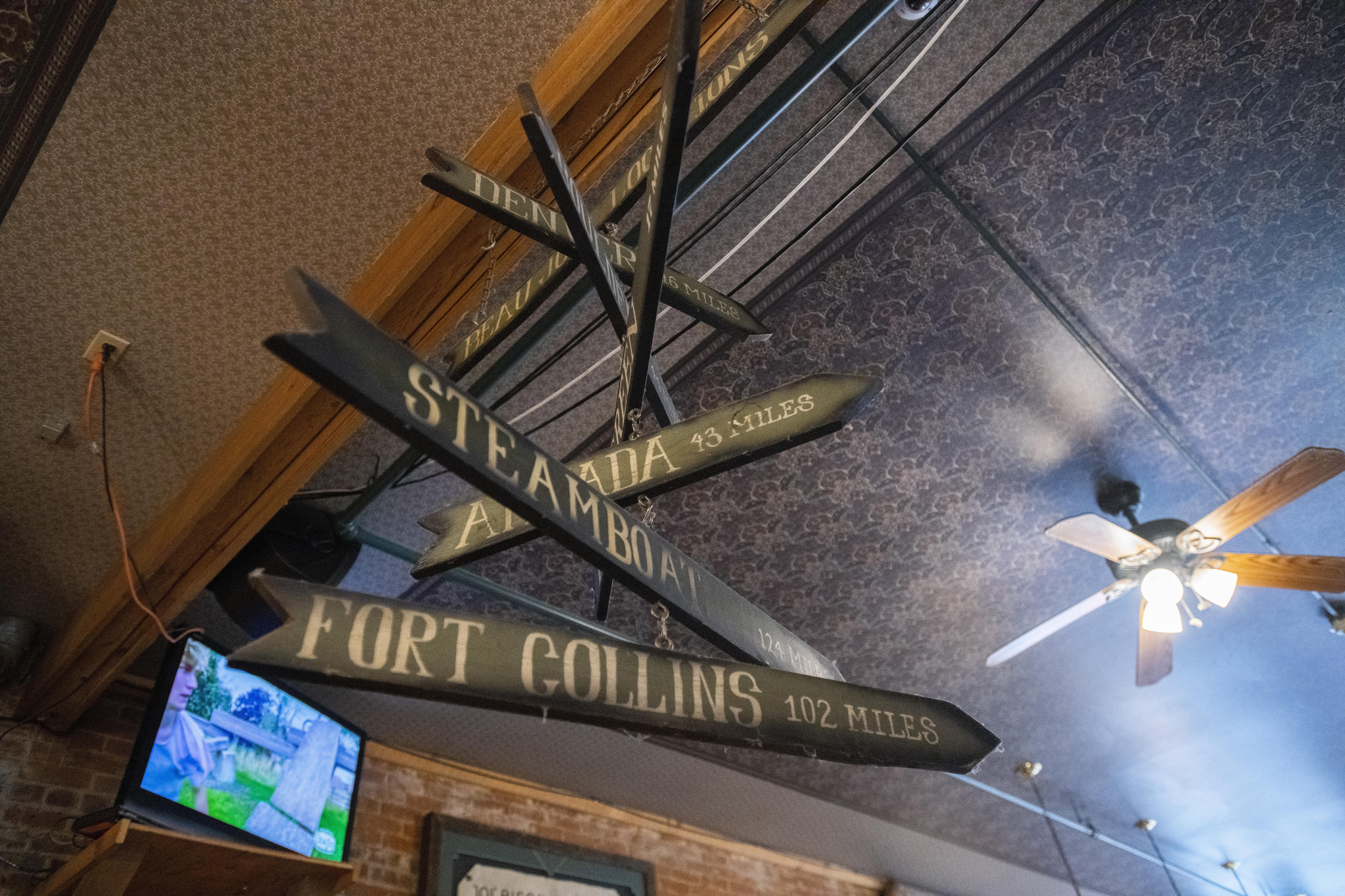 Signs pointing to the other Beau Jo’s restaurants hang from the ceiling of the original pizzeria in Idaho Springs.010722-fam-craving 4.jpg (Christian Murdock, The Gazette)