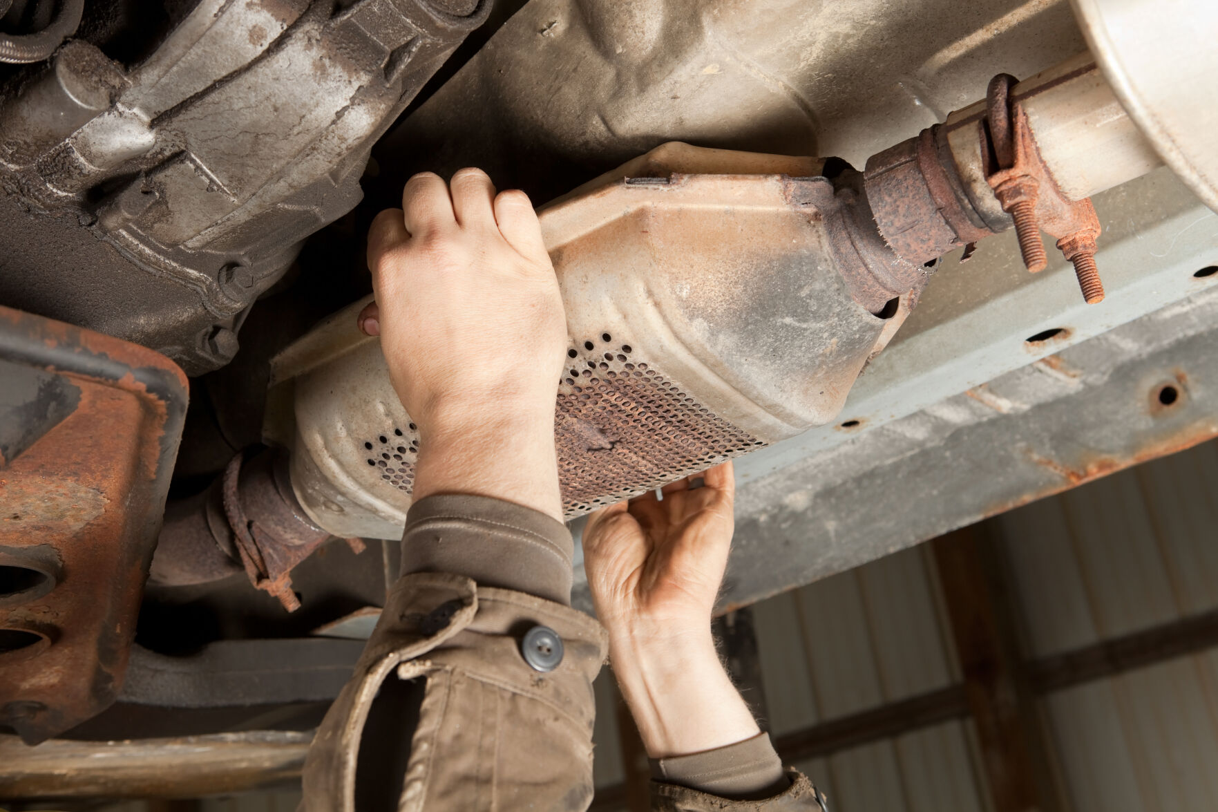 An SUV's catalytic converter being removed at a salvage yard. (iStock) (BanksPhotos)