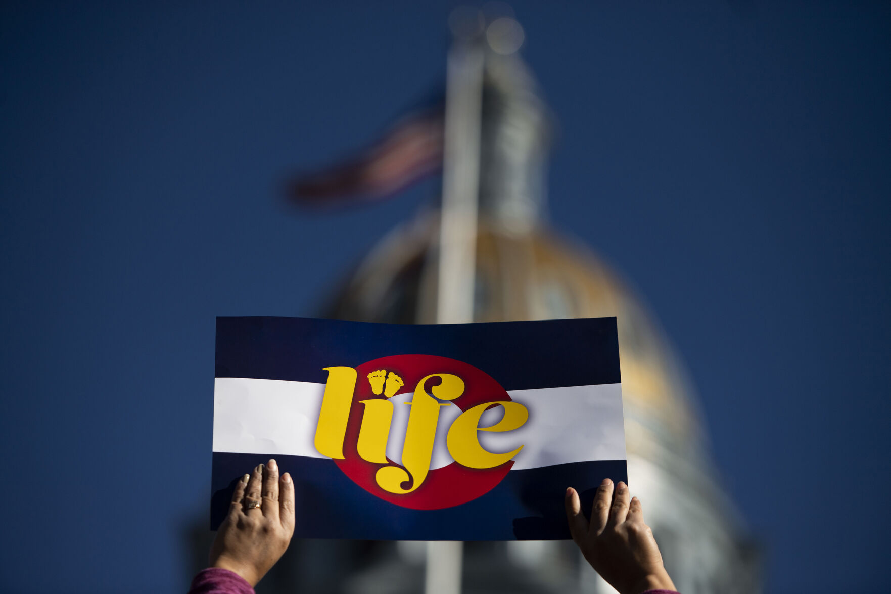 People hold up signs during the Celebrate Life Rally and March, hosted by the Archdiocese of Denver and Respect Life Denver, at the Colorado State Capitol building in Denver, Colo., on Saturday, Jan. 15, 2022. Thousands attended the annual event honoring courageous mothers. (Chancey Bush/ The Gazette) (Chancey Bush/ The Gazette)