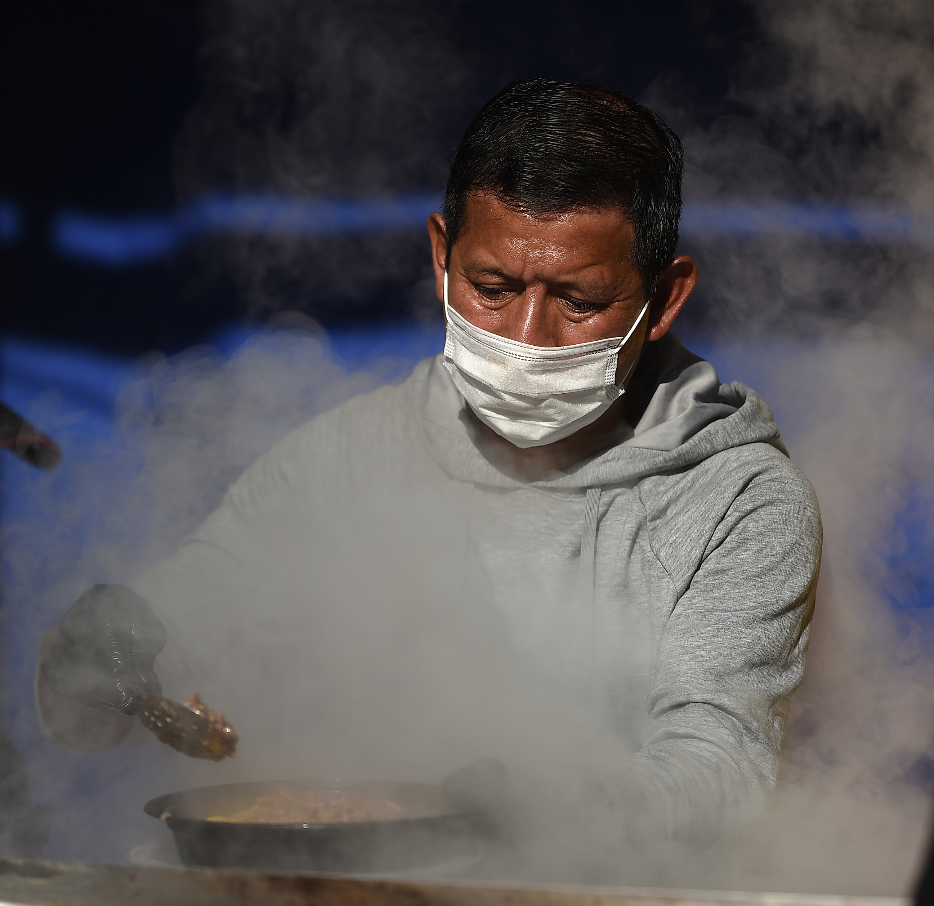 Steam rises from the griddle of one of the many vendors on Sunday, Jan. 23, 2022. Sunday was the last day of the last day of the National Western Stock Show. (Photo by Jerilee Bennett, The Gazette) (Jerilee Bennett)
