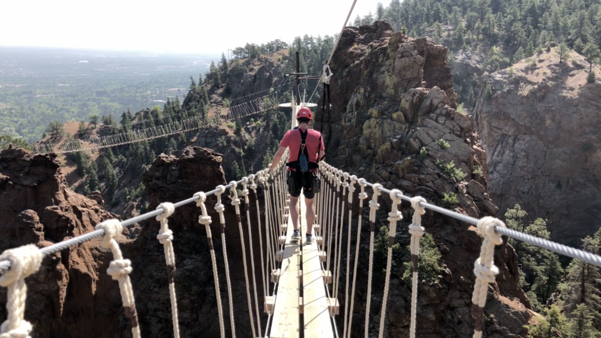 Spencer McKee walks across a portion of The Broadmoor's Soaring Adventures Zipline Course, recently rated as one of the top attractions in the country. The course is found in Colorado Springs, Colorado.Photo Credit: Stephen Martin.