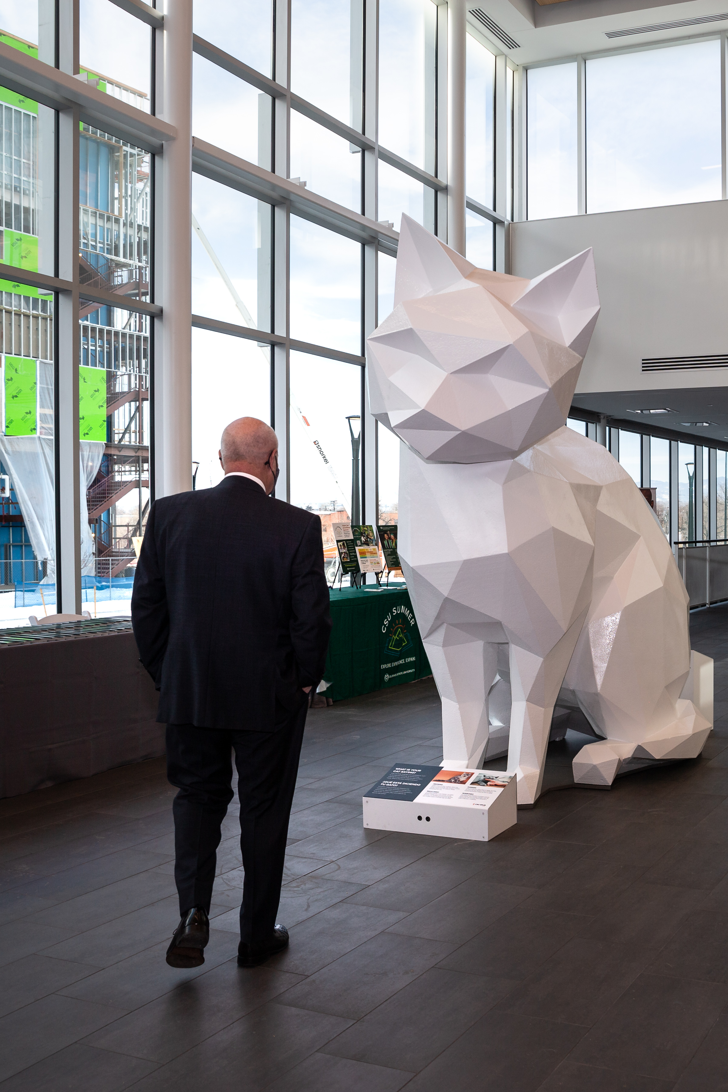 Jeff Keener, President and CEO of the South Metro Denver Chamber, observes a sculpture of a cat in the foyer of the new Vida Building on the Colorado State University Spur campus on Friday, Jan. 7, 2022, in Denver, Colo. The interactive sculpture is designed to teach visitors about feline behavior. (Liz Copan / special to The Denver Gazette) (Liz Copan)