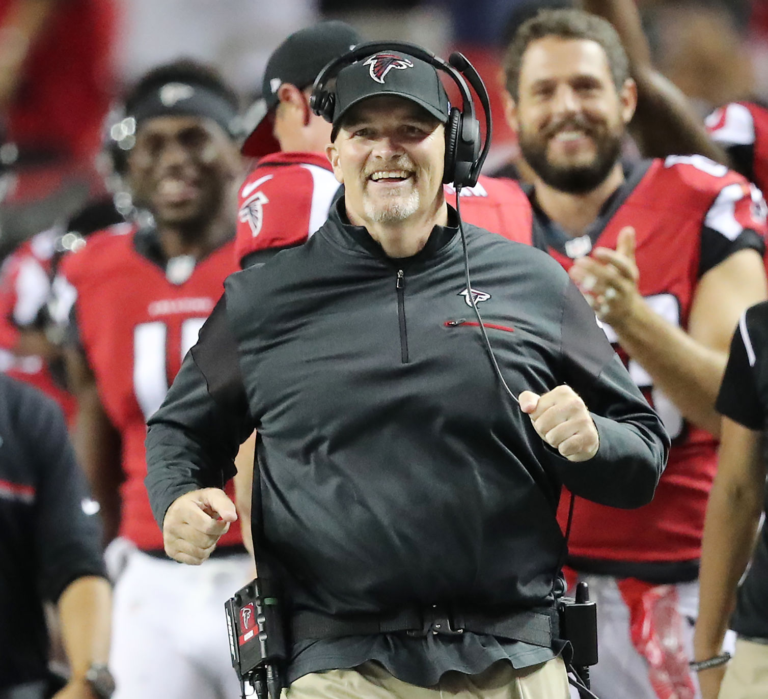 Atlanta Falcons head coach Dan Quinn smiles as he runs down the sidelines during a preseason NFL football game against the Washington Redskins, Thursday, Aug. 11, 2016, in Atlanta. (Curtis Compton/Atlanta Journal Constitution via AP) (Curtis Compton)