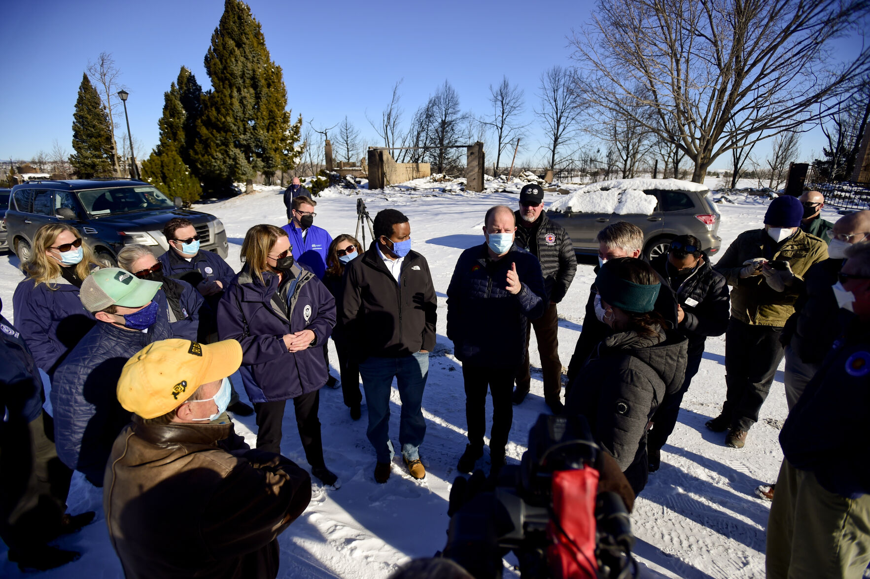 LOUISVILLE, CO - JANUARY 2:Colorado Gov. Jared Polis, center, talks with Louisville Mayor Ashley Stolzmann, right, during a tour of the Marshall Fire burn area in Louisville on Sunday, Jan. 2, 2022. The current estimate of destroyed structures is 991, while 127 structures are damaged according to Boulder County Sheriff Joe Pelle. (Matthew Jonas/Boulder Daily Camera/Pool) (Matthew Jonas)