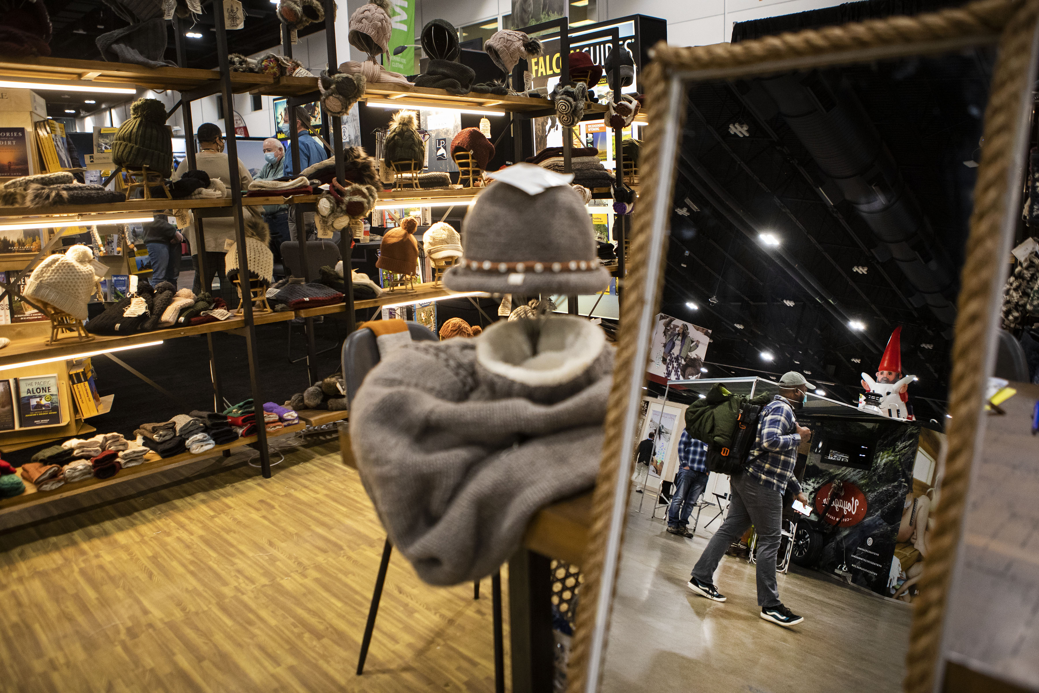 Gerry James with Outdoor Recreation Roundtable walks the expo hall past the Nirvana Designs booth during the second day of the Outdoor Retailer Snow Show at the Colorado Convention Center on Thursday, Jan. 27, 2022, in Denver, Colo. (Timothy Hurst/The Gazette) (Timothy Hurst)