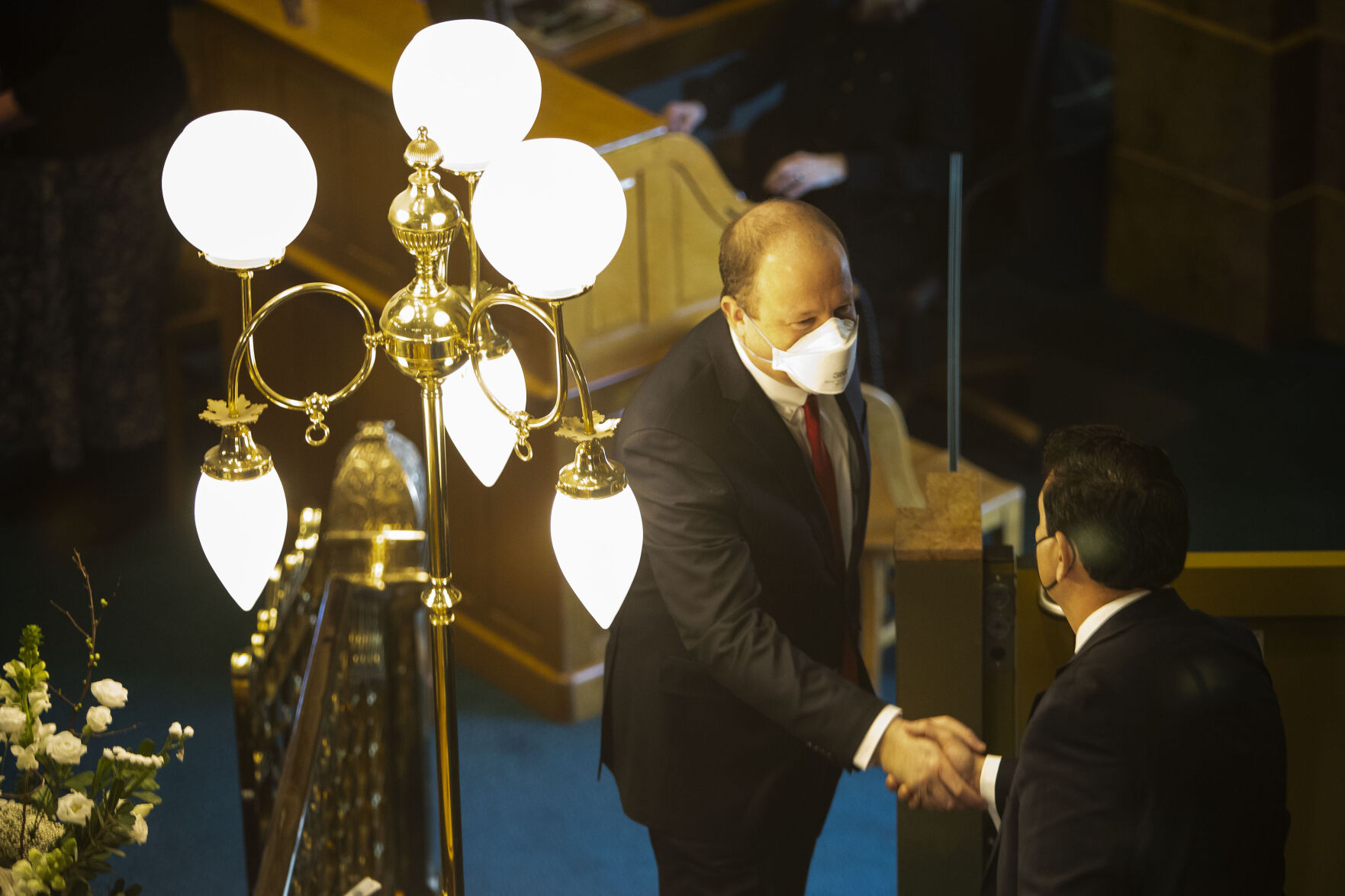 Gov. Jared Polis is greeted by President of the Senate Leroy Garcia before delivering his State of the State address on Thursday, Jan. 13, 2022, in Denver, Colo. (Timothy Hurst/The Gazette) (Timothy Hurst)