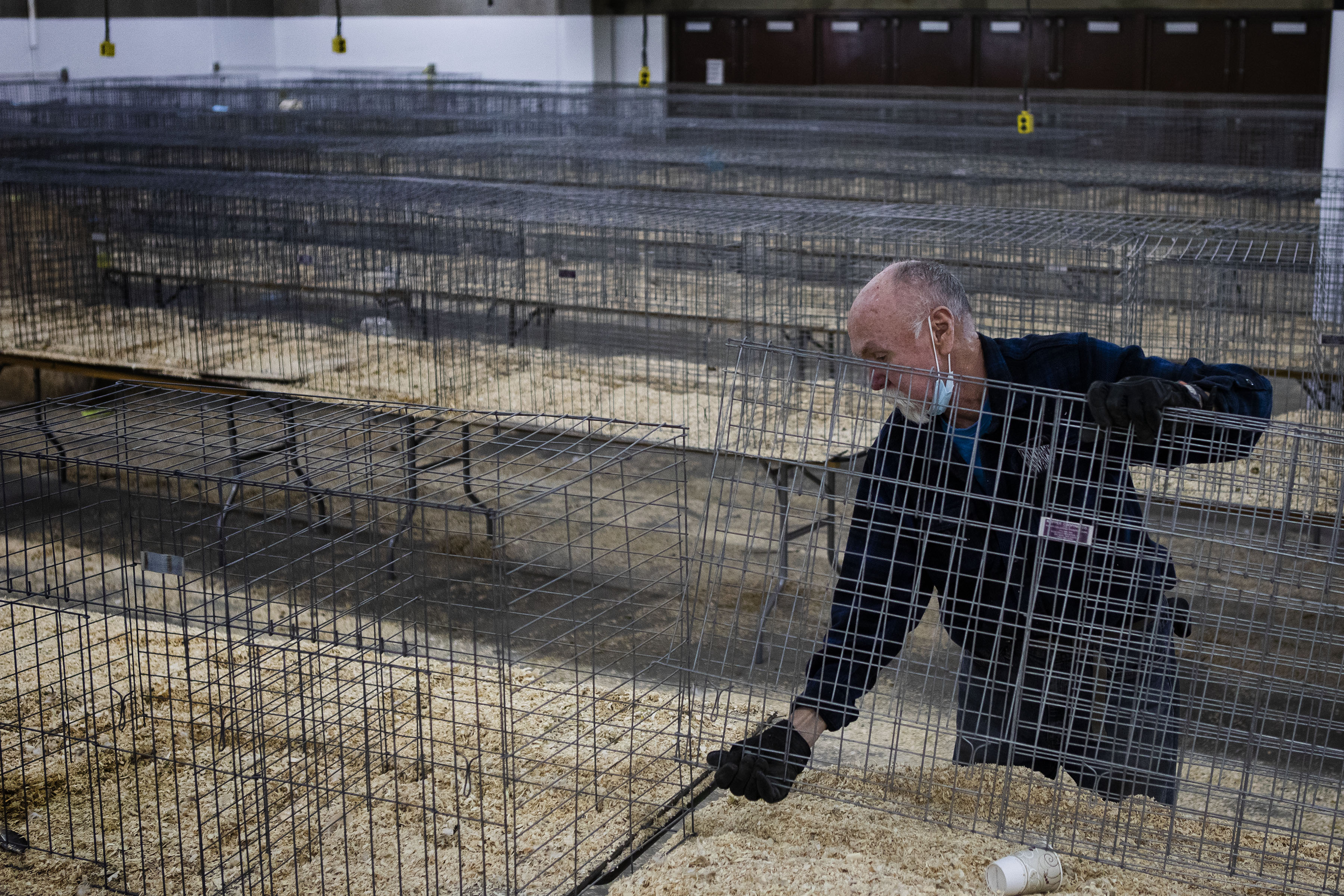 Temporary worker Randall Beyer disassembles rows of poultry cages in the National Western Stock Show’s Hall of Education after the stock show’s last day on Monday, Jan. 24, 2022, in Denver, Colo. (Timothy Hurst/The Gazette) (Timothy Hurst)