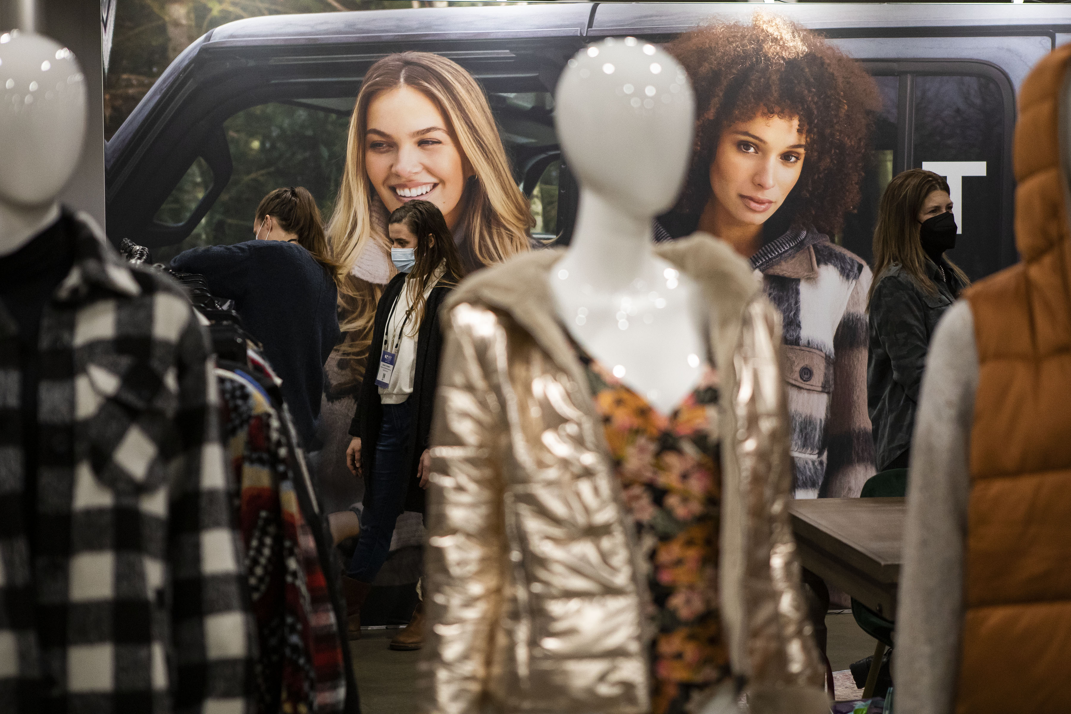 Christy Stempky, left, and Emily Eckhart, both with Nourish Northern Michigan LLC, check out the clothing racks at Tribal Fashion display the during the second day of the Outdoor Retailer Snow Show at the Colorado Convention Center on Thursday, Jan. 27, 2022, in Denver, Colo. (Timothy Hurst/The Gazette) (Timothy Hurst/The Denver Gazette)