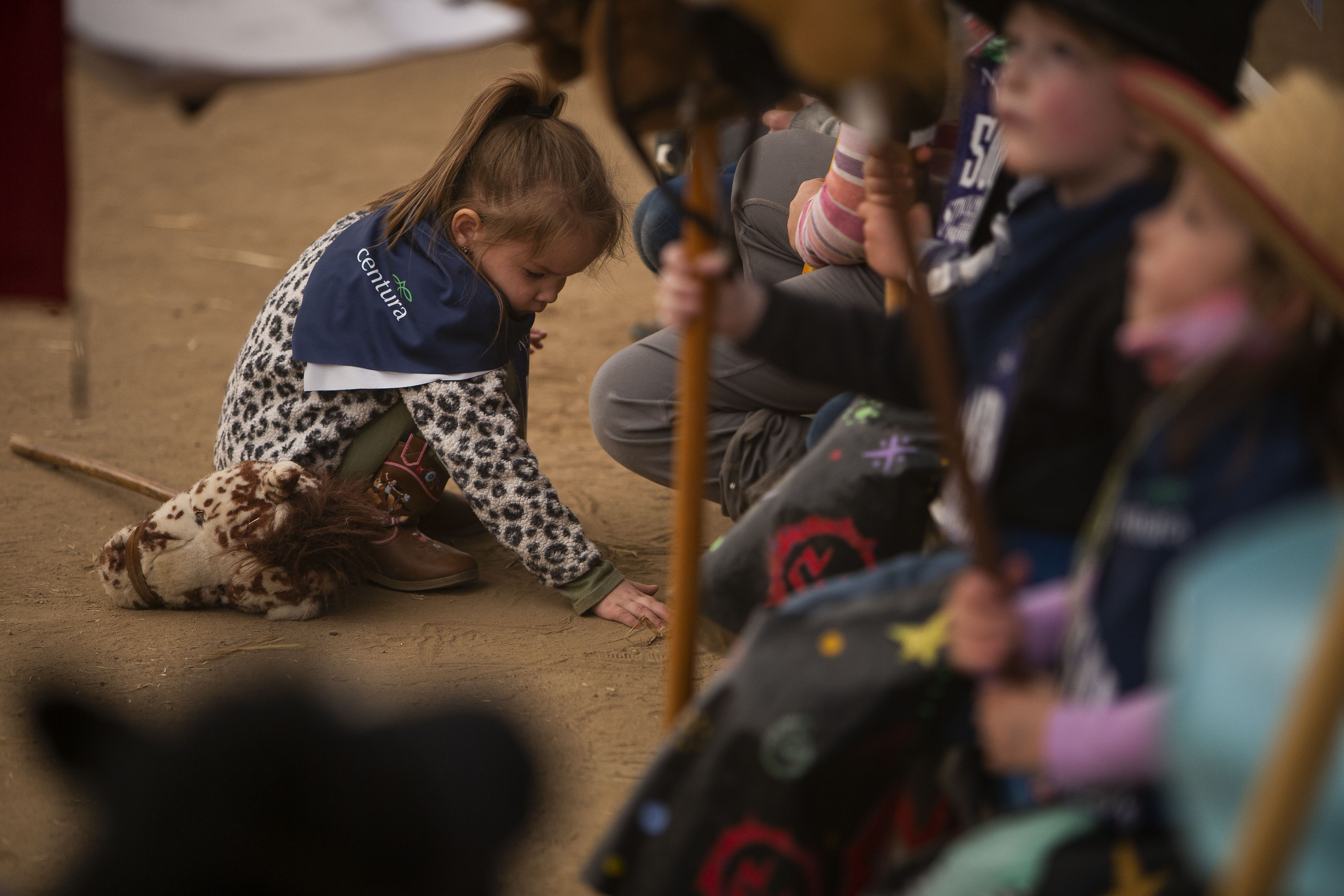 The National Western Stick Horse Rodeo participant Zoan Rodriguea, 3, takes a minute to play in the dirt while her competitions waits during a free grounds admission day at the National Western Stock Show on Tuesday, Jan. 11, 2022, in Denver, Colo. (Timothy Hurst/The Gazette) (Timothy Hurst)