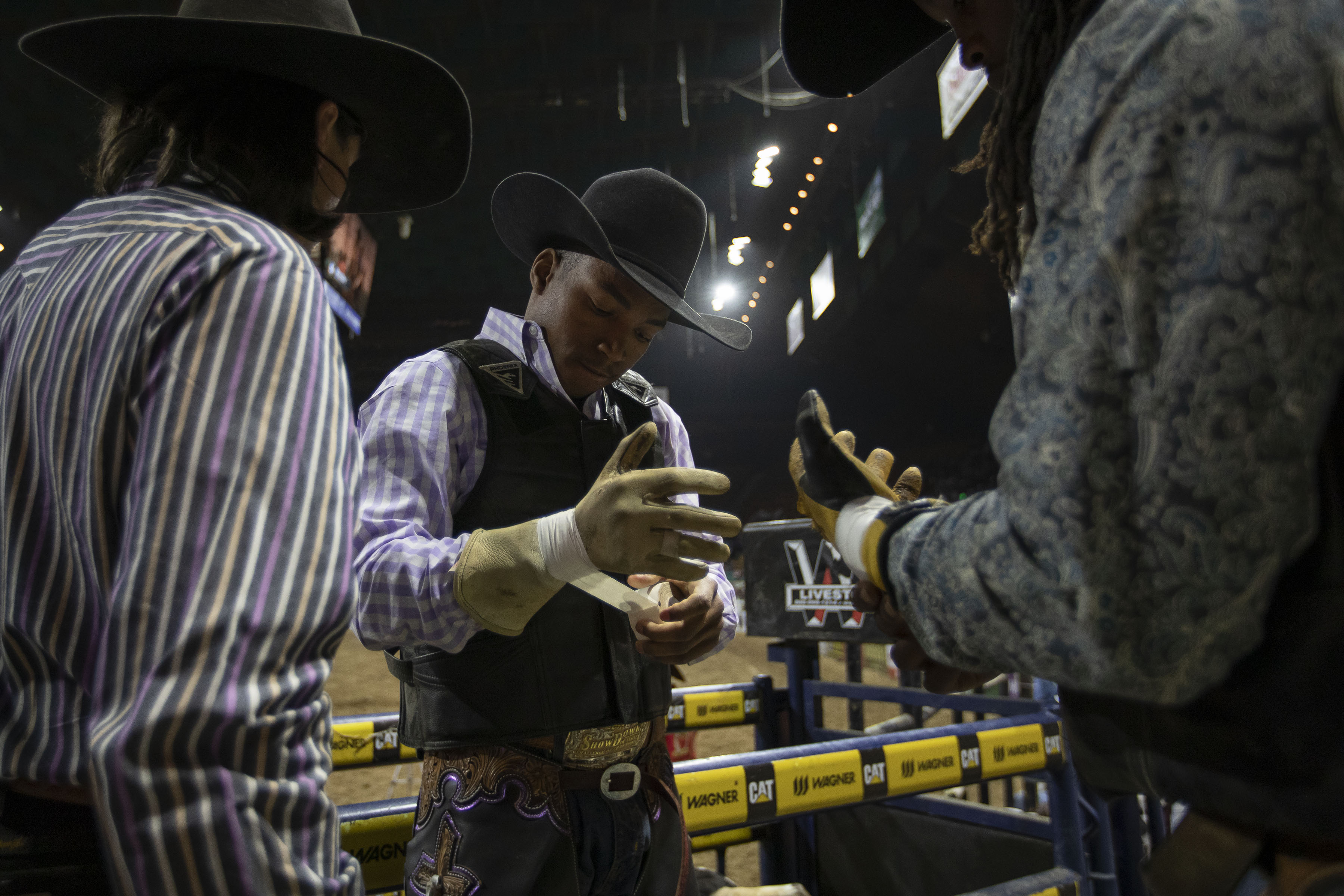 Bullrider Blaine Devers tapes the wrists of his gloves before riding bull Rico during the African-American Heritage Rodeo at the National Western Stock Show on Monday, Jan. 17, 2022, in Denver, Colo. (Timothy Hurst/The Gazette) (Timothy Hurst)