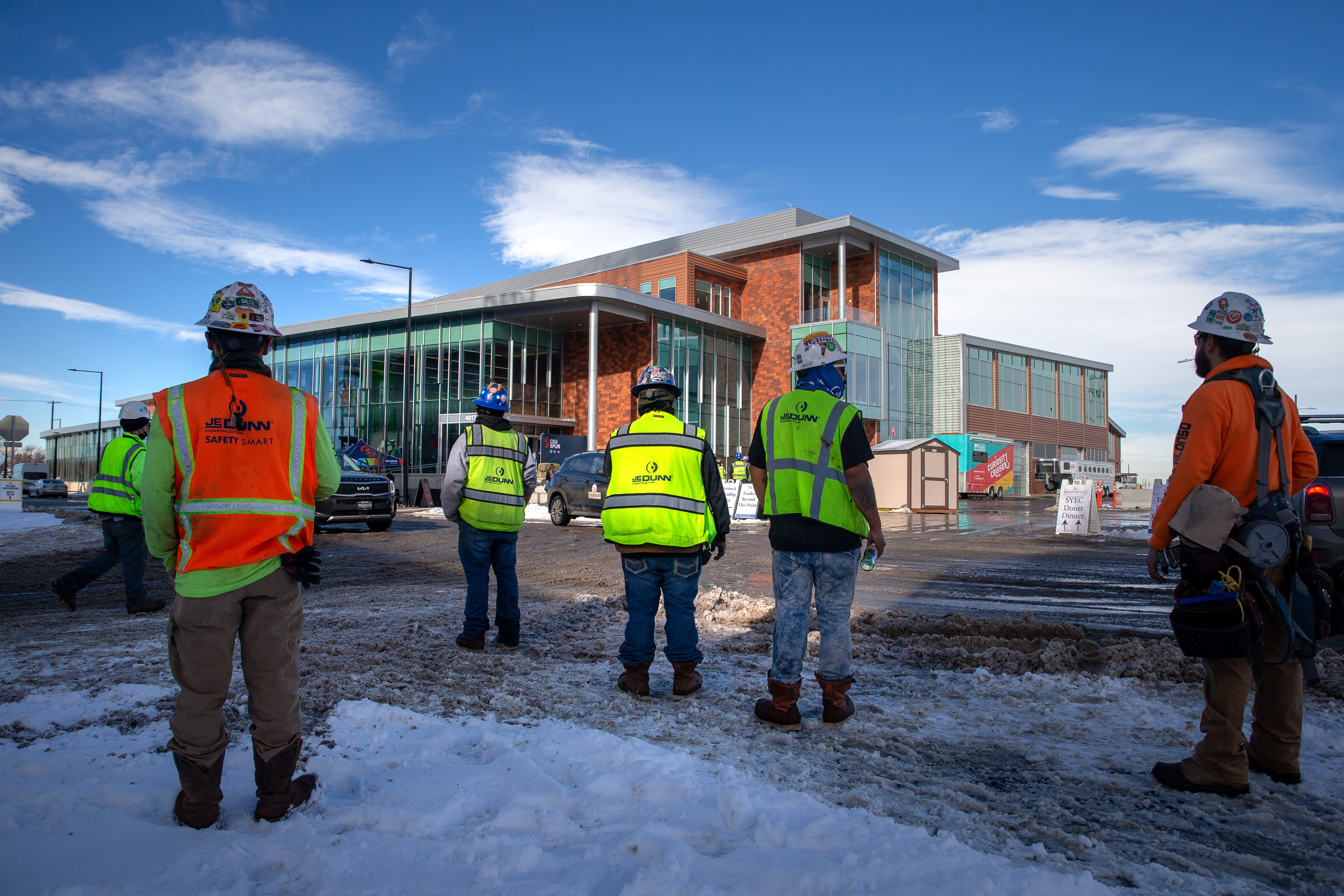 Construction crew members of the Colorado State University Spur campus Vida building wait for its official opening on Friday, Jan. 7, 2022, in Denver, Colo. (Liz Copan / special to The Denver Gazette) (Liz Copan)