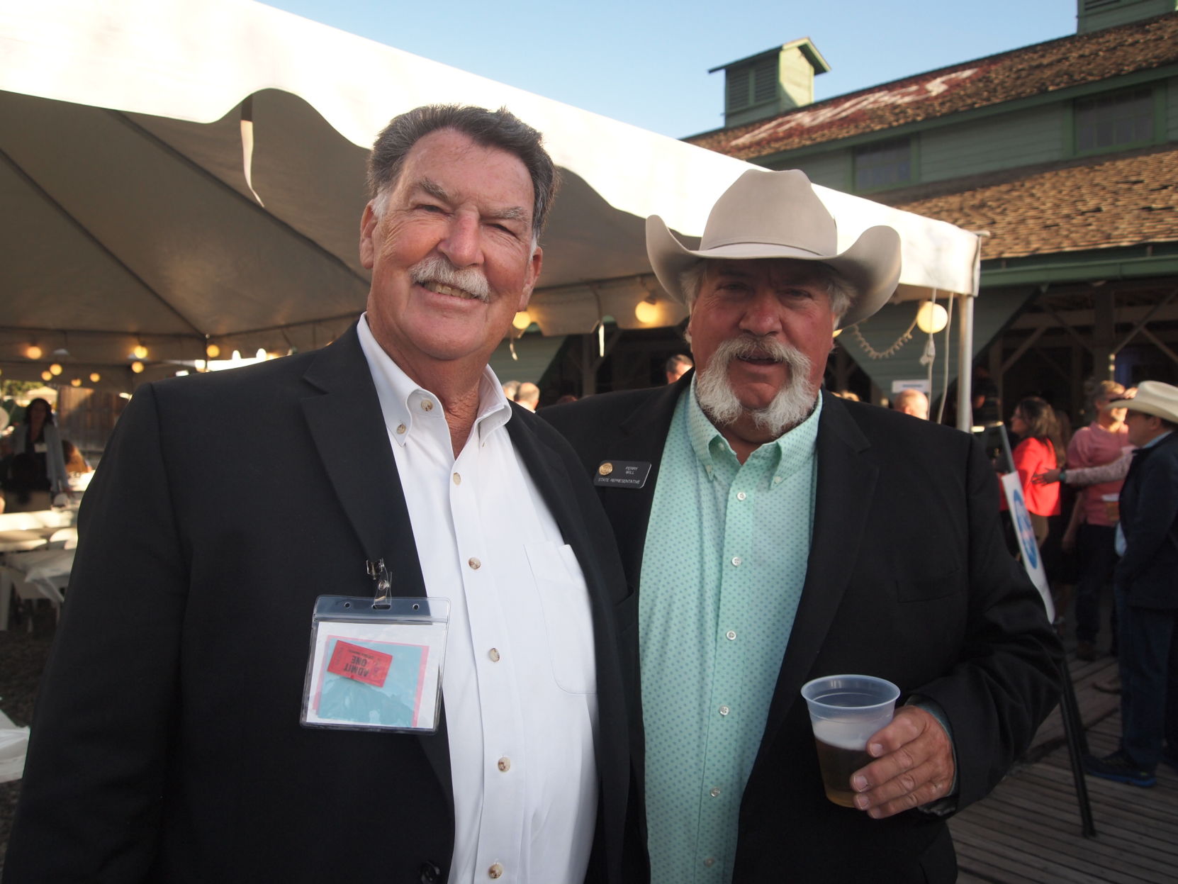State Sen. Don Coram, R-Montrose, (left) and state Rep. Perry Will, R-New Castle, (right) at the 2019 Club 20 steak fry. (Photo by Marianne Goodland, Colorado Politics.)