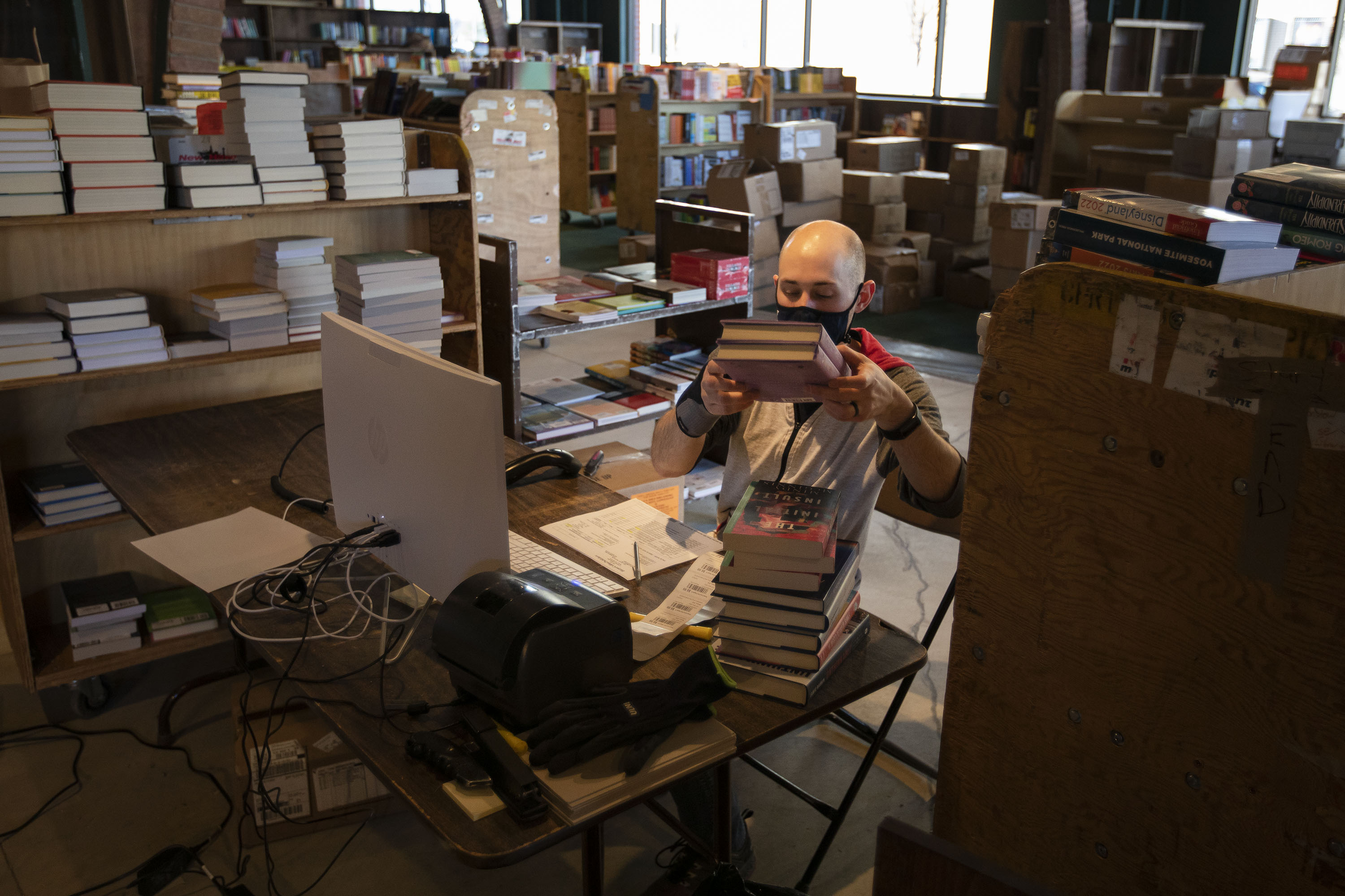 Tattered Cover book seller James Persichetti goes through boxes of new books as part of the receiving process Tuesday in preparation of the store opening it’s newest location in Westminster. (TimHursttim.hurst@gazette.comhttps://secure.gravatar.com/avatar/aca82bd62b4ee425c598527cd6faa1b1?d=mm&r=g)